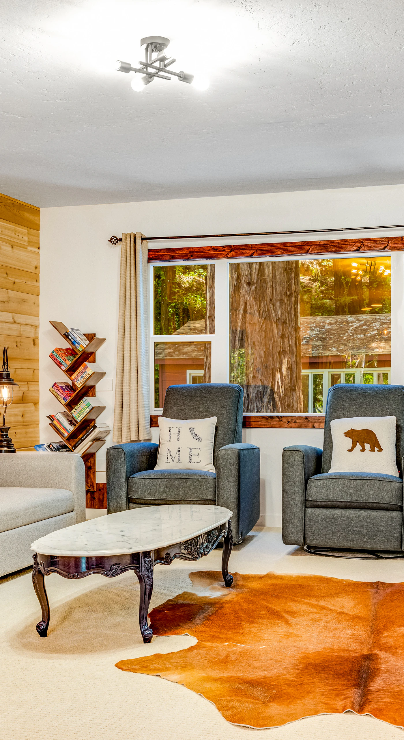Settle into your cozy living room with a wood-planked accent wall, cast-iron stove, and rustic bear-country touches after a day exploring Sonoma wine country.