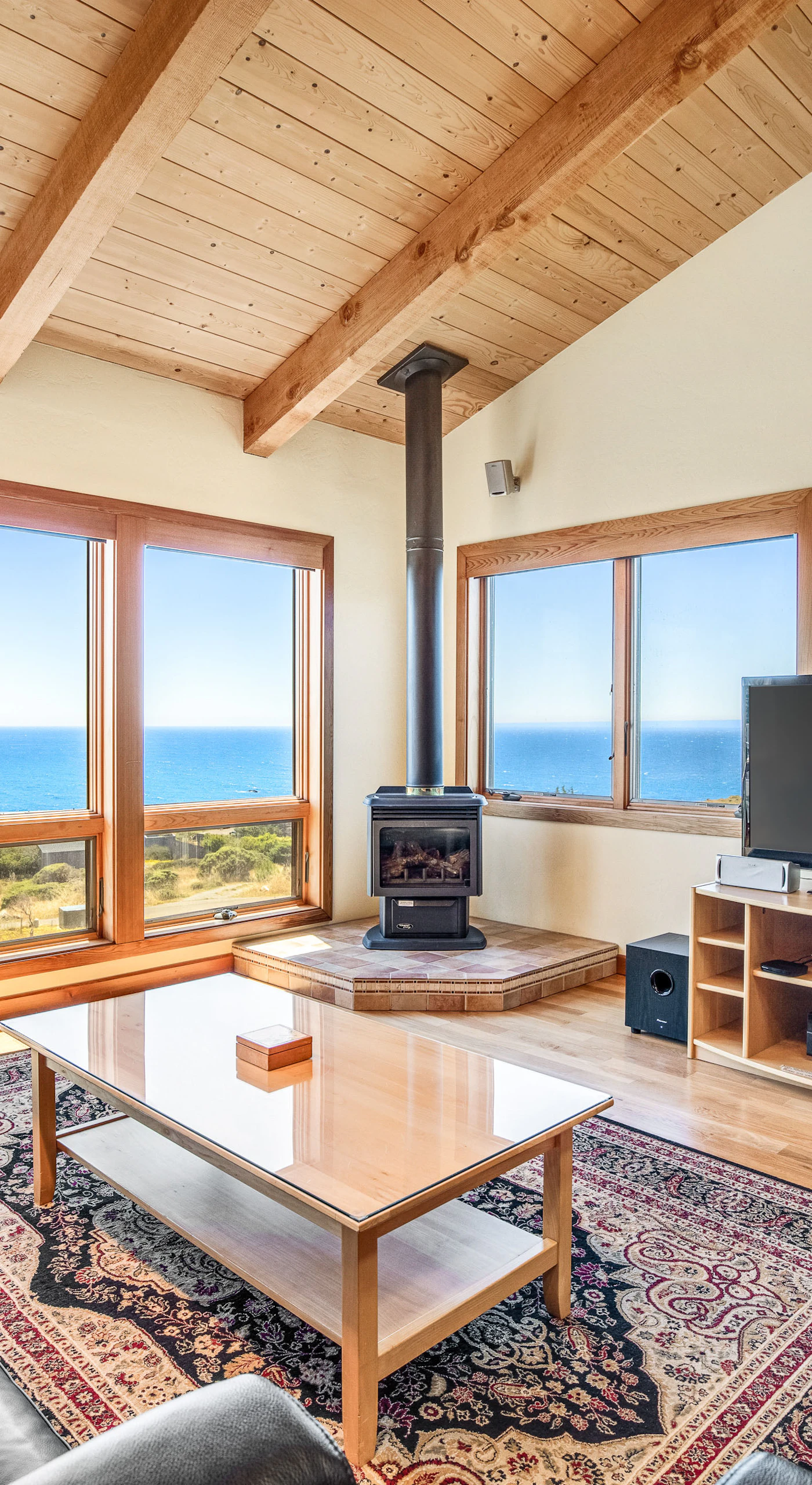 Gaze out at the ocean from your cozy living room, where the warmth of the gas fireplace invites relaxation after a day of adventure.