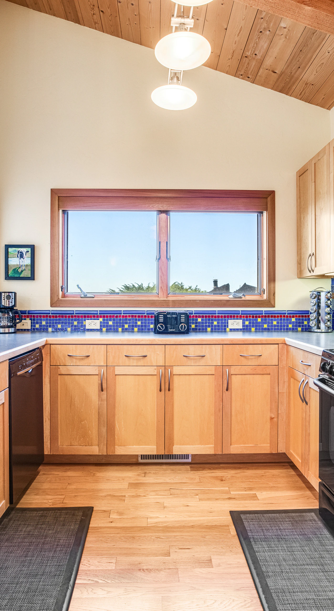 Cook up a storm in the well-equipped kitchen, featuring vibrant tiles that inspire culinary creativity amidst beautiful surroundings.