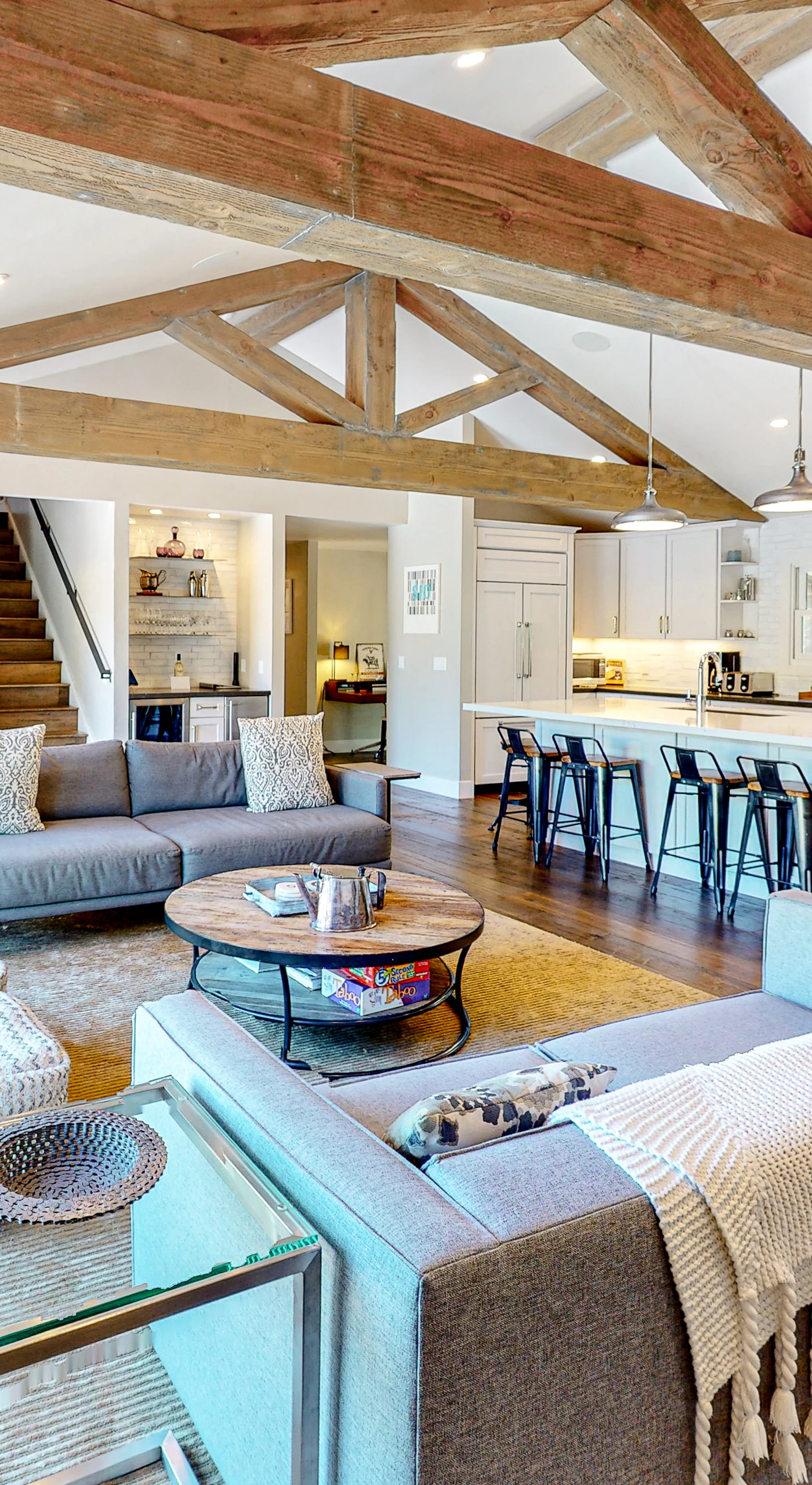 Soaring exposed timber beams crown your open-concept great room, where plush sofas and a chef's kitchen invite long Sonoma Valley evenings with your favorite bottle.