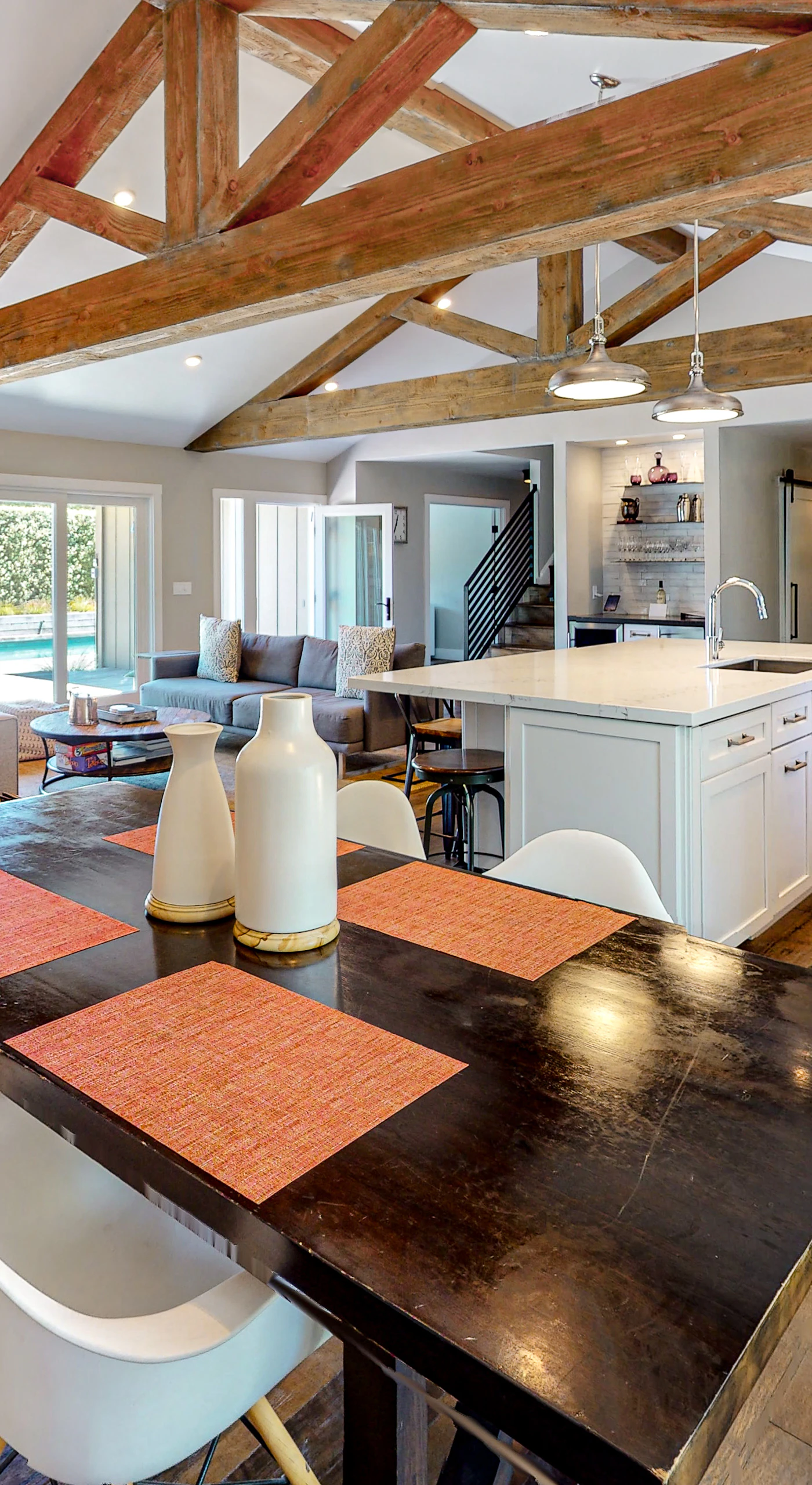 From your farmhouse dining table, watch the chef work the open kitchen — exposed beams and a generous island connect every guest to the conversation.