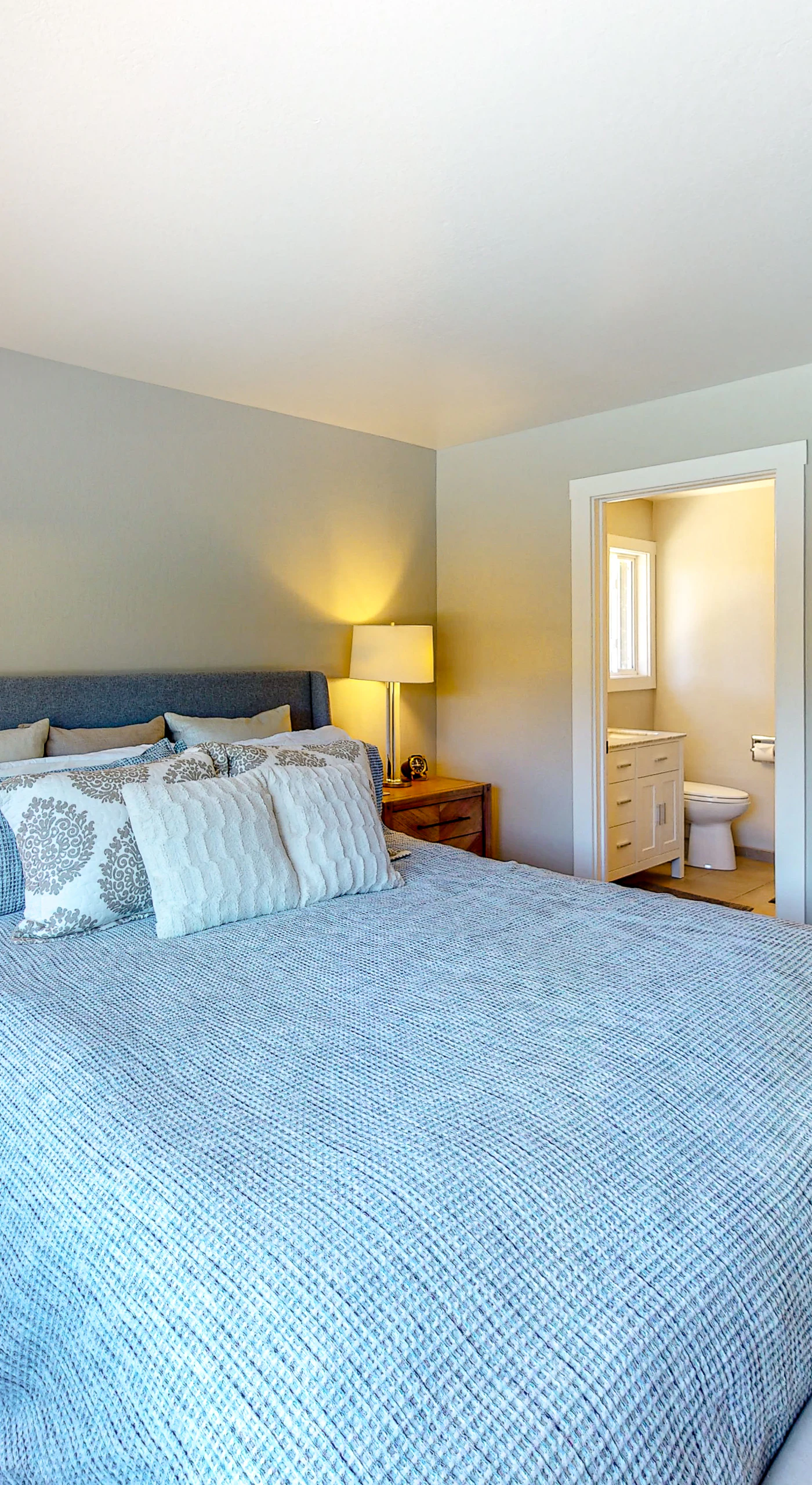 Retreat to your king-size sanctuary with an upholstered headboard, dual nightstands, and direct access to an en-suite bath and walk-in closet — pure Sonoma comfort.