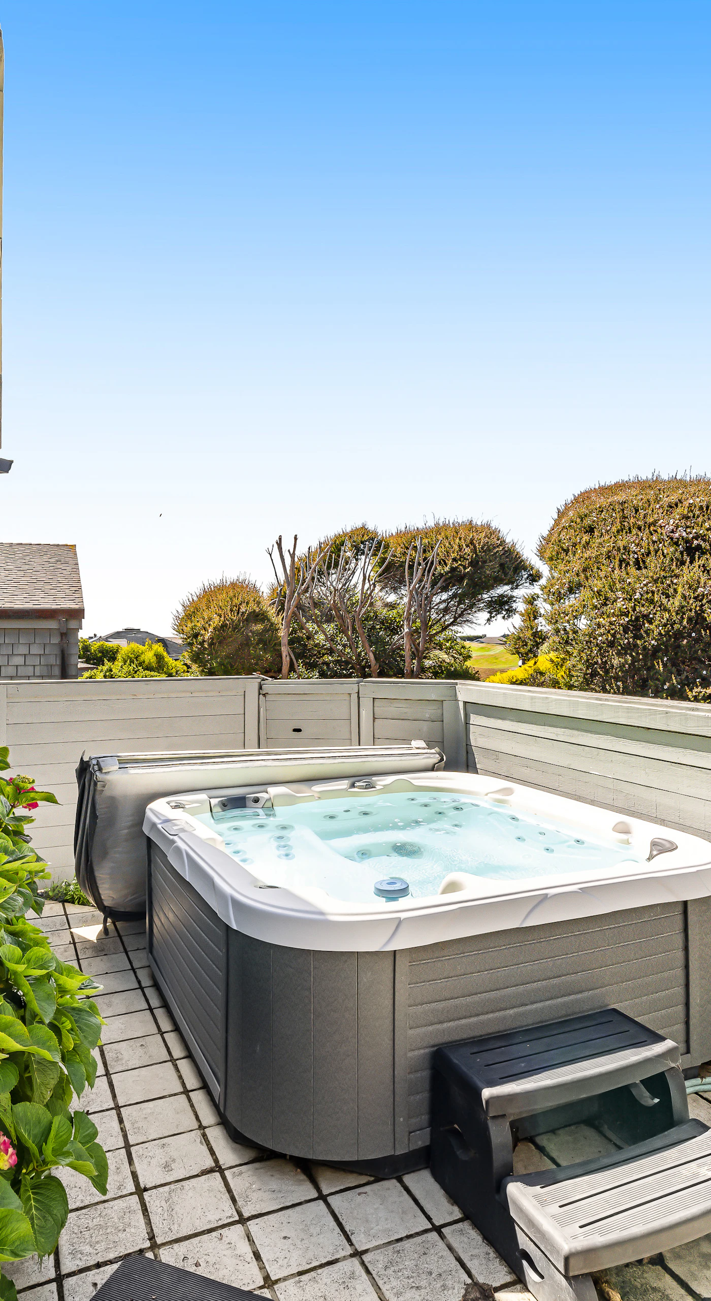 Soak away the sea breeze chill in your private hot tub surrounded by blooming hydrangeas — the perfect Bodega Bay wind-down after a day of coastal exploring