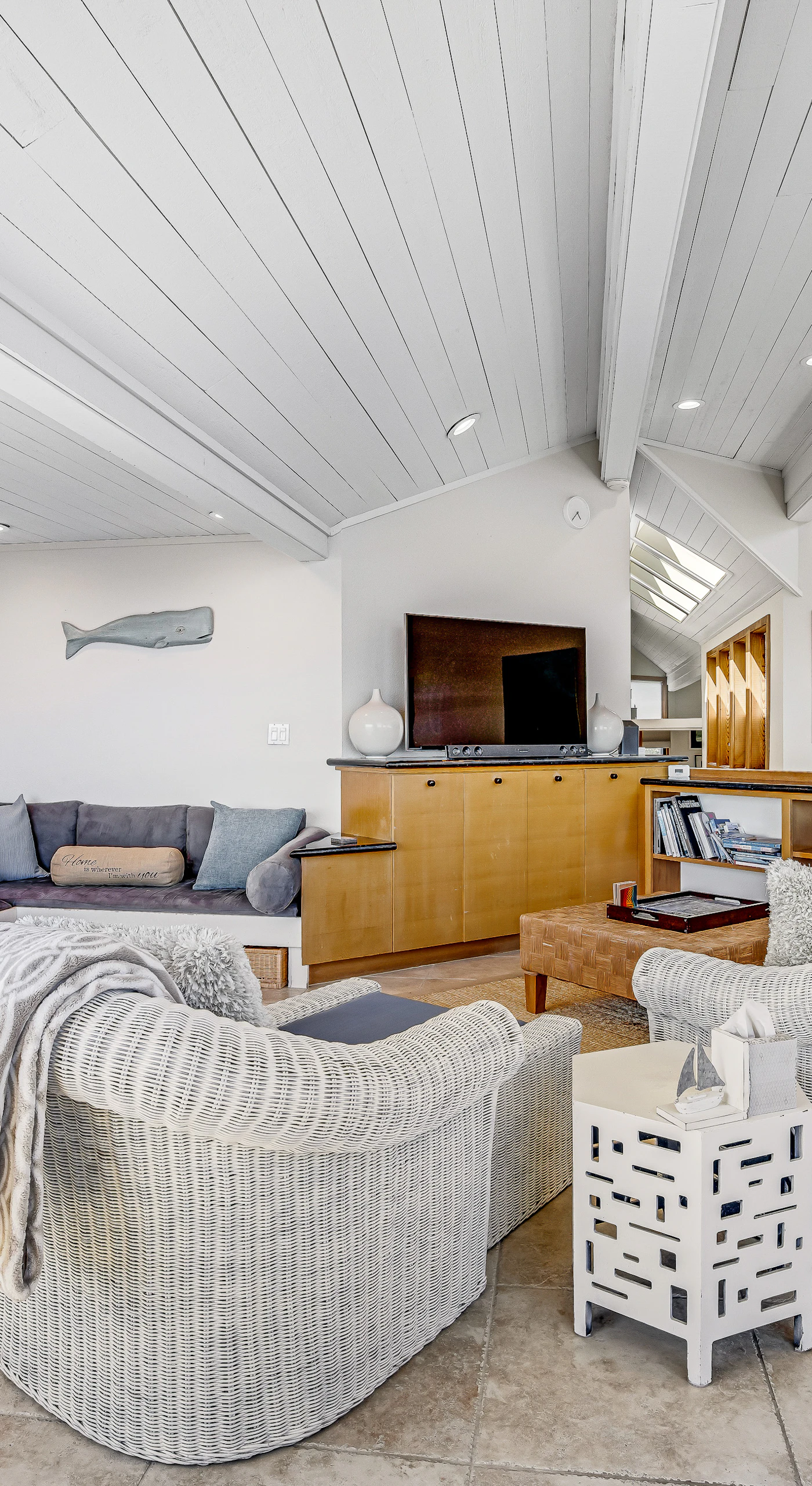 Local coastal artwork lines your vaulted-ceiling retreat, with built-in bench seating that invites lingering conversations after long Sonoma Coast days