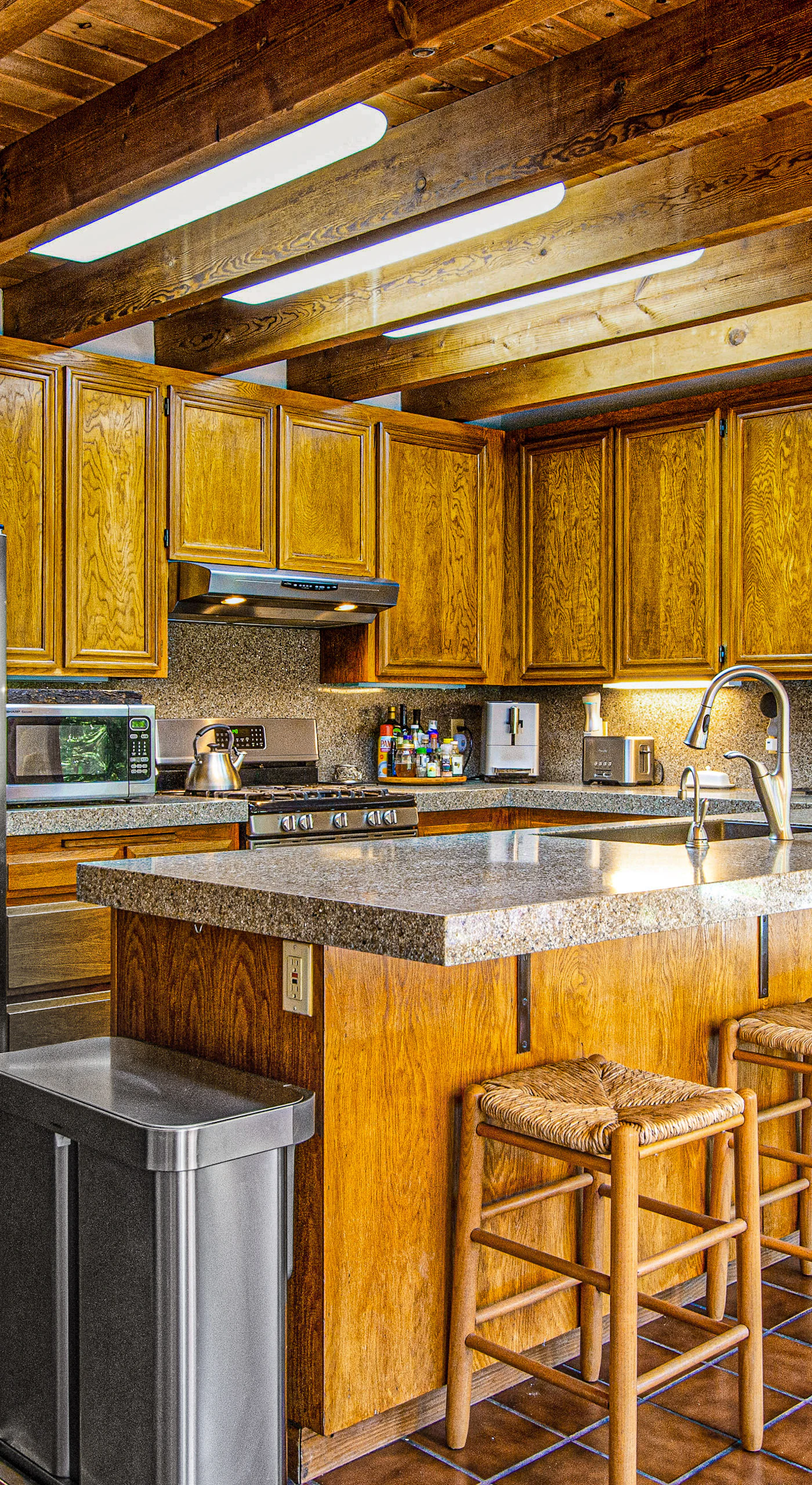 Cook like a local in your full chef's kitchen — stainless steel appliances, granite counters, a breakfast bar, and skylit beamed ceilings make meal prep a pleasure.