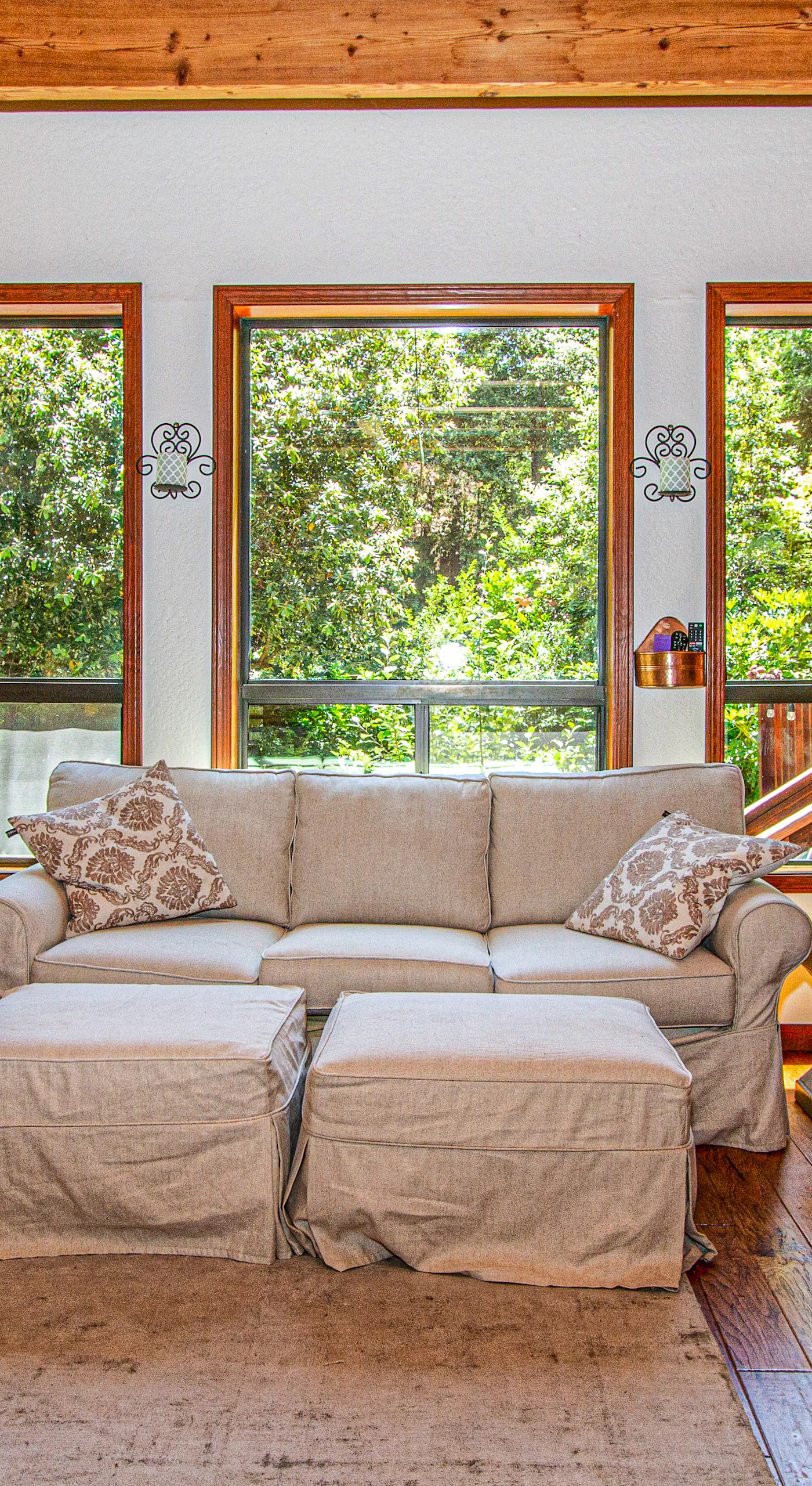 Sunlight pours through oversized windows into your living room, framing lush redwood views while you stretch out on the comfy sofa after a day exploring Sonoma.
