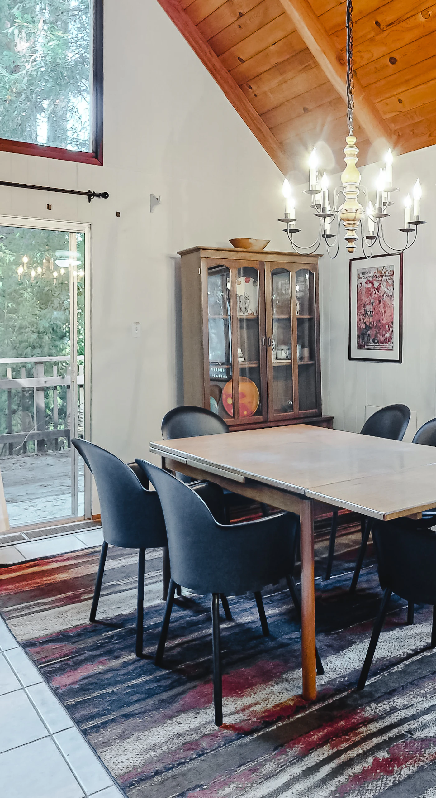 Sunlight streams through panoramic windows onto your dining space — redwood views and elegant touches make every meal feel like a special occasion.