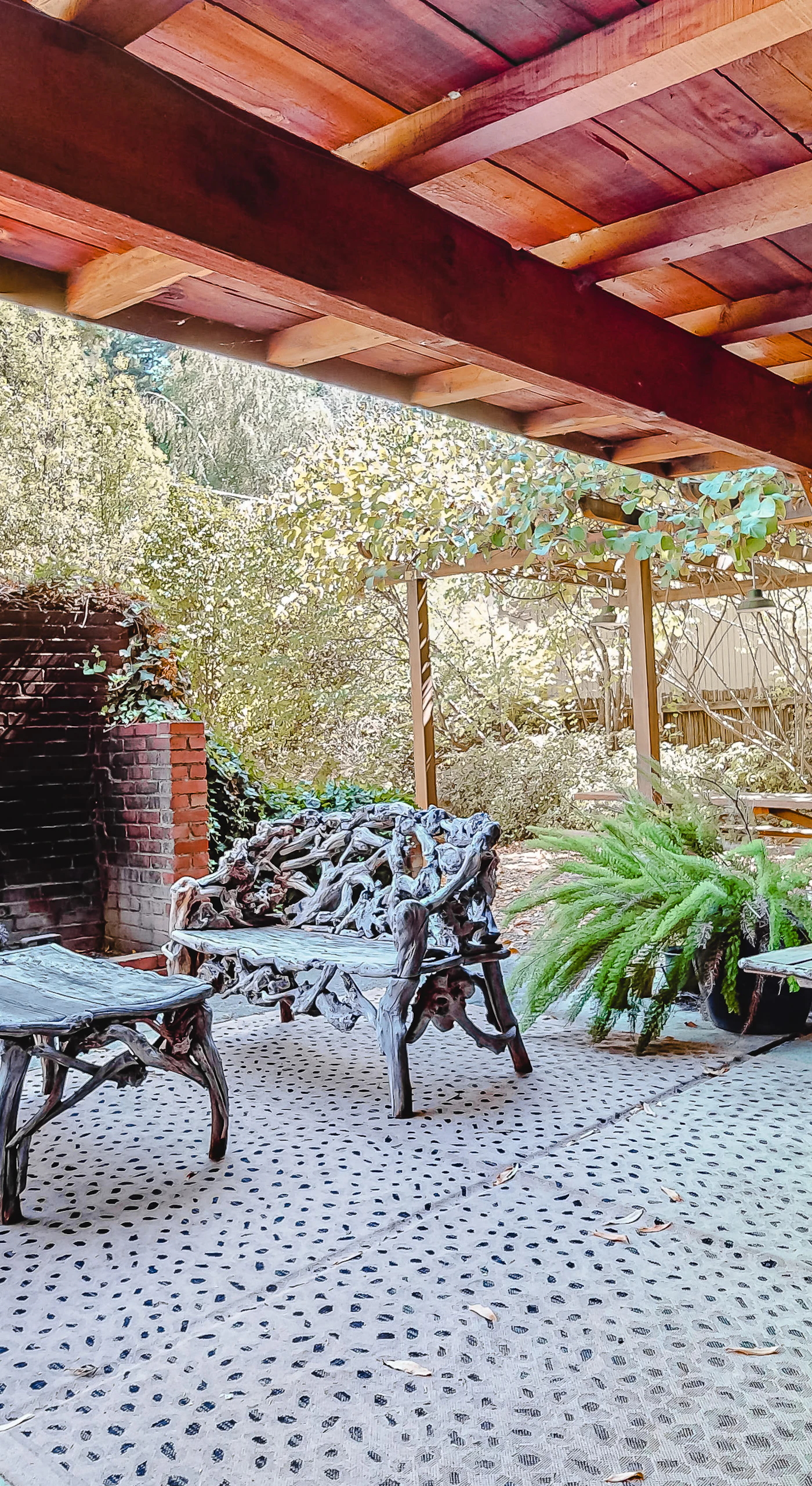 Unwind beneath your private covered patio — wrought-iron seating, a brick hearth, and a picnic table set the scene for lazy redwood afternoons along the Russian River.