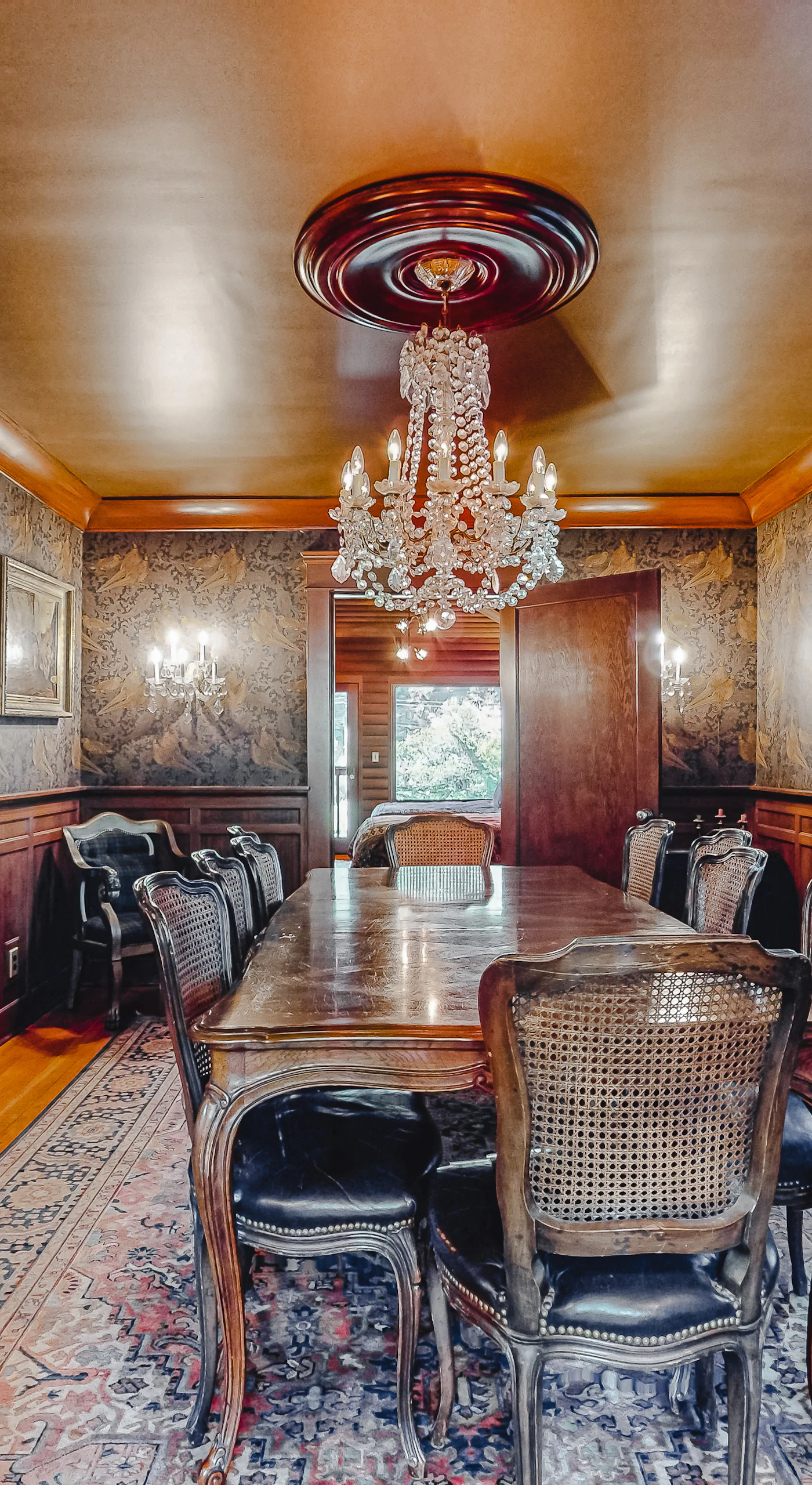 Every Sonoma supper feels like an occasion at your grand dining table — dark wainscoting, a glittering chandelier, and seating for the whole party.