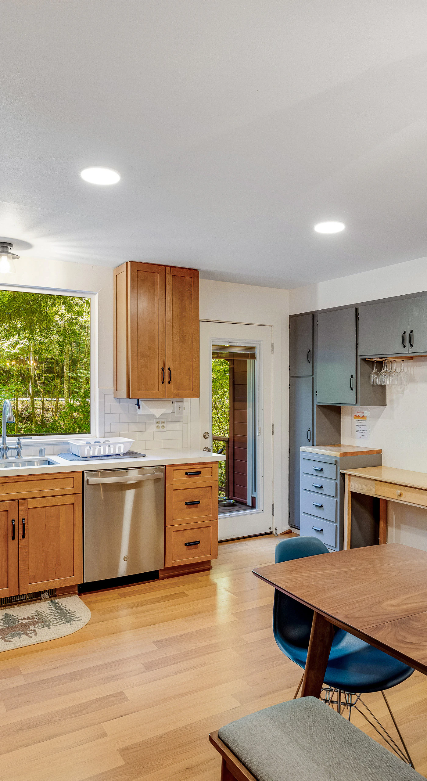Everything you need to prepare a gourmet Cazadero dinner — gas range, stainless dishwasher, coffee maker, and leafy green views from the oversized window.