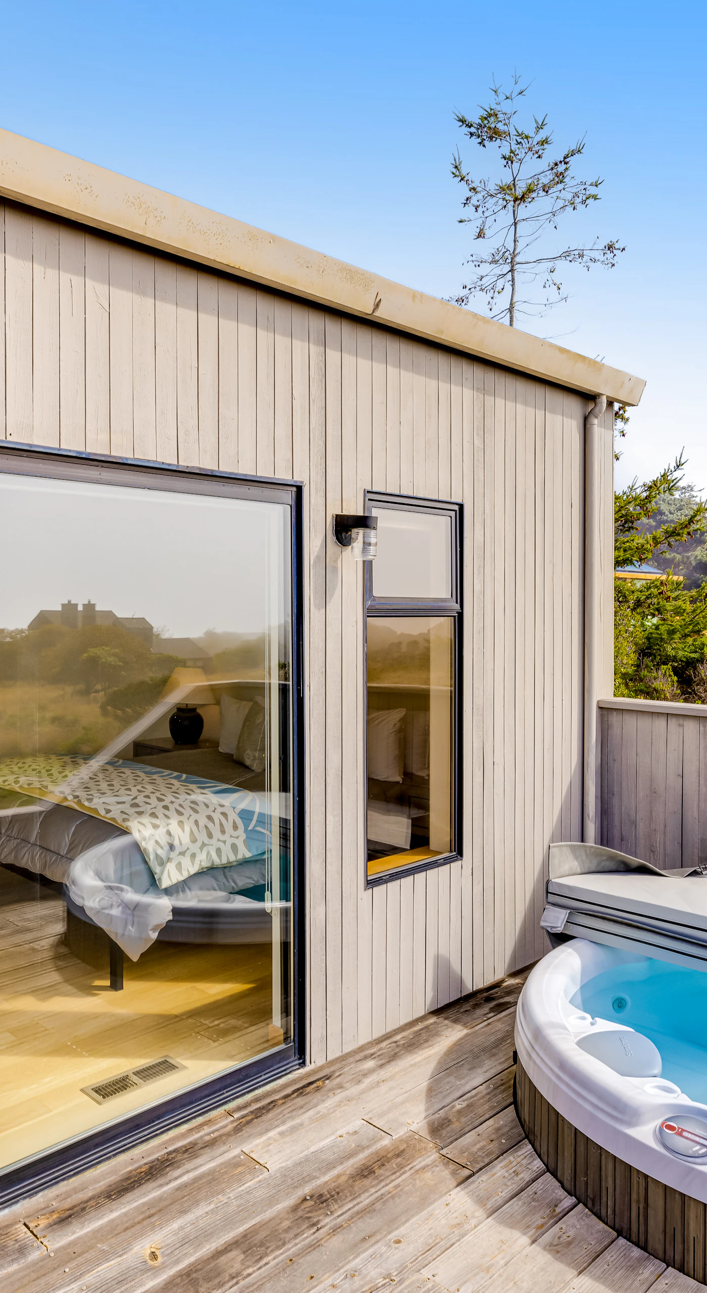 Relax in your private hot tub, surrounded by nature, the perfect spot to unwind after a day of coastal adventures.