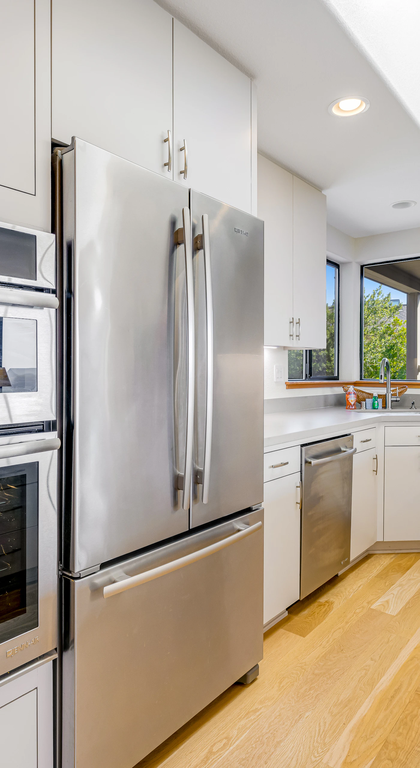 Your sleek kitchen awaits culinary creations, featuring ample counter space and modern appliances for effortless meal prep.