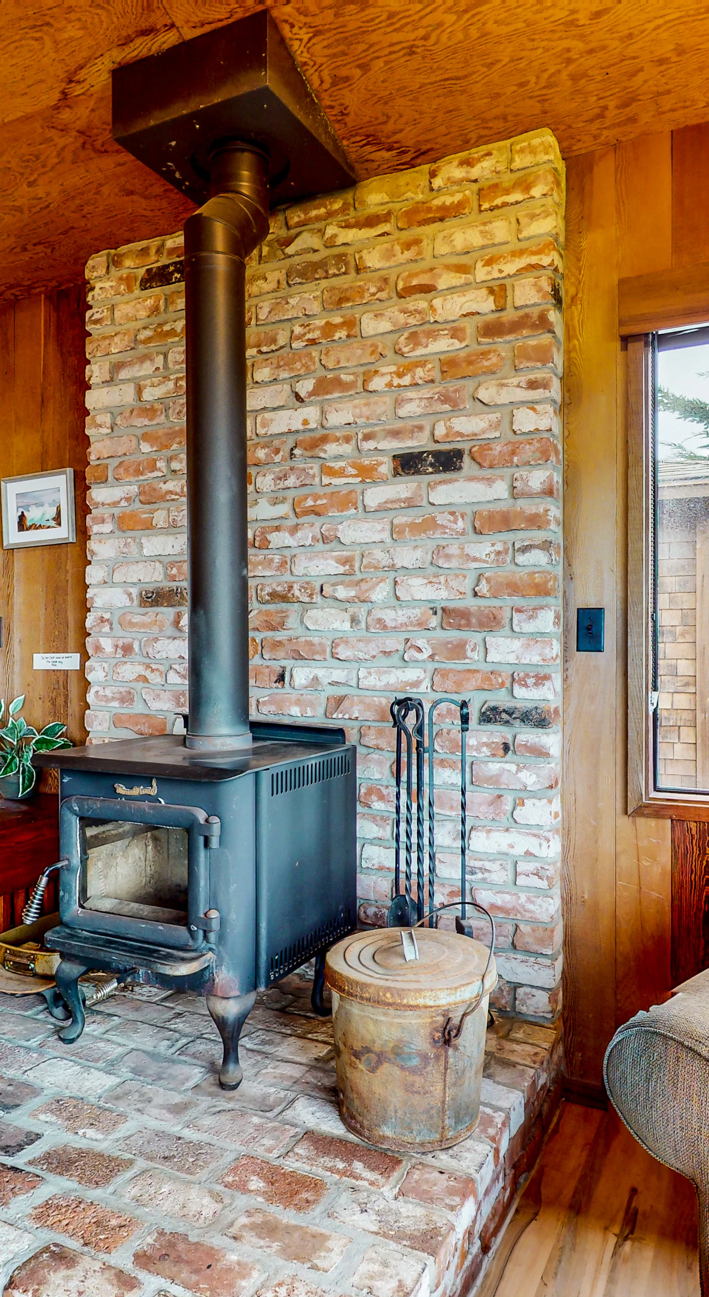 The rustic charm of the wood-burning stove adds warmth and character to your Sea Ranch retreat.
