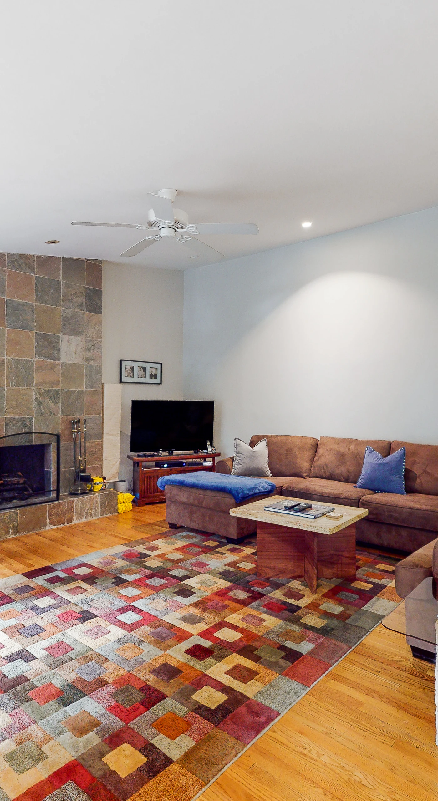 Settle into your spacious redwood retreat living room — a stone fireplace, plush sectional, and warm hardwood floors set the scene for cozy Russian River evenings after a day of wine tasting.