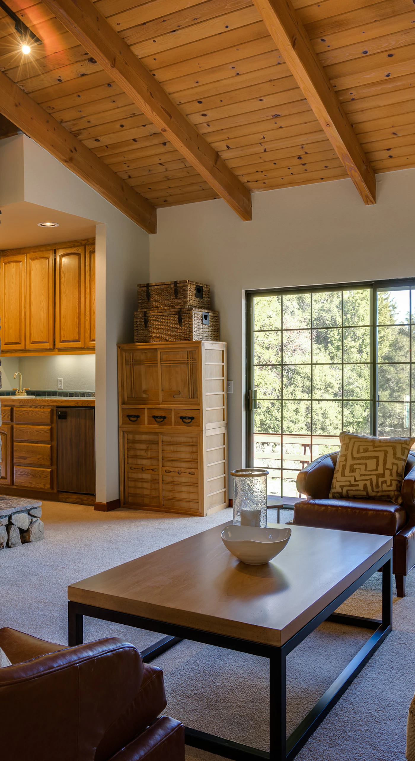 Sink into soft leather beside a crackling stone fireplace while the warmth of exposed wood beams wraps around you like wine country itself.