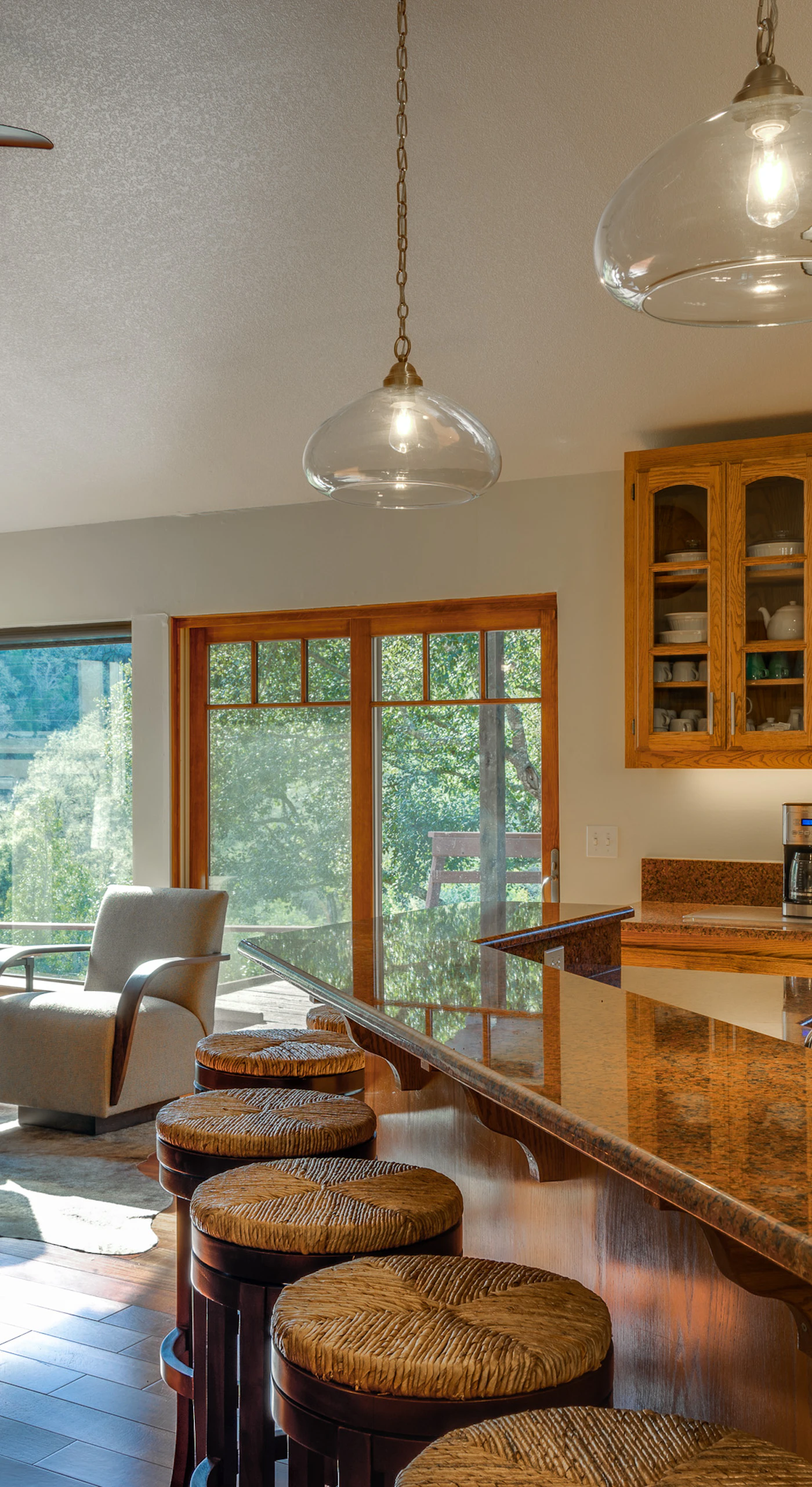 Morning light floods through picture windows as you brew coffee at the granite island — sunlit breakfast nook and cozy gas stove steps away.