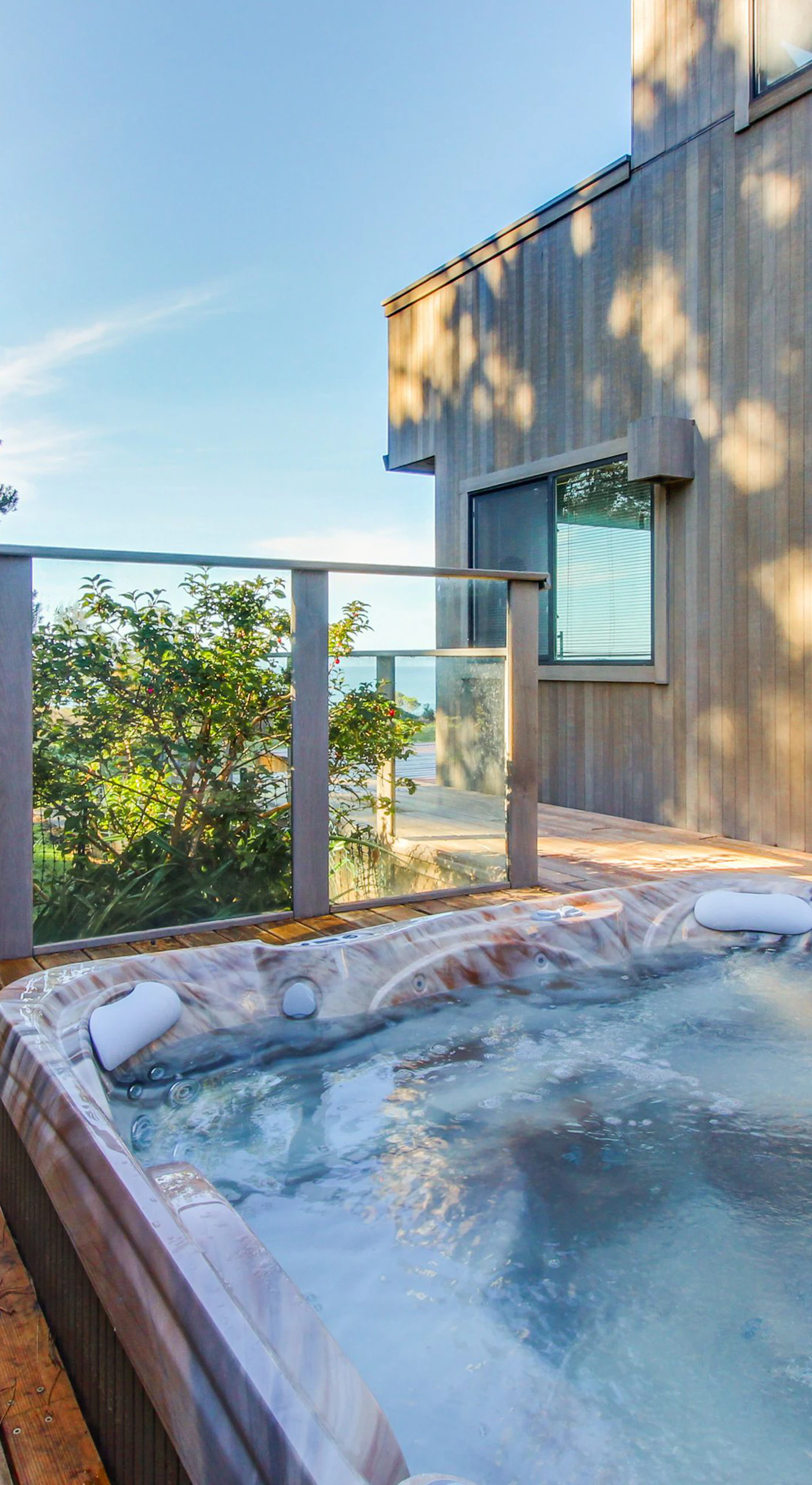 Sink into relaxation in your private hot tub, where every soak offers a chance to unwind while enjoying the coastal scenery.