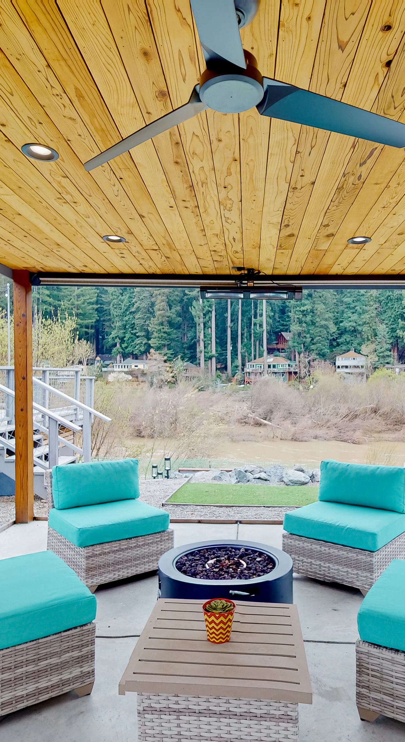 Unwind beneath your private covered pavilion with plush seating and a fire pit table — towering redwoods and the Russian River set the scene for unforgettable Monte Rio evenings.