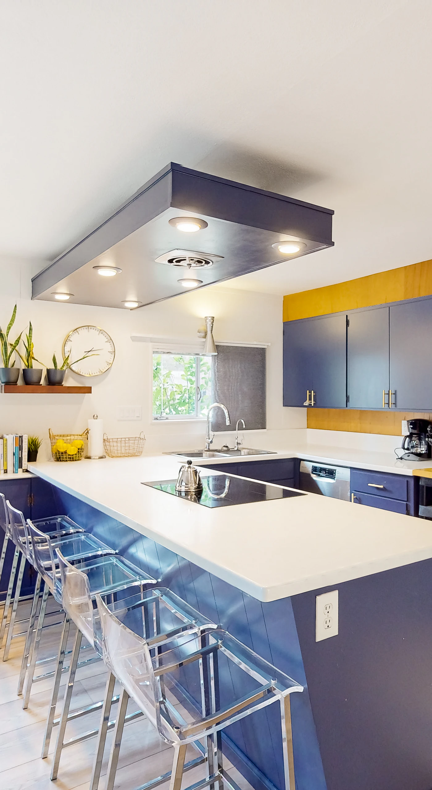 Channel your inner chef in a bold designer kitchen — sleek navy cabinetry, white quartz countertops, and a spacious island with bar seating make cooking a highlight of your stay.