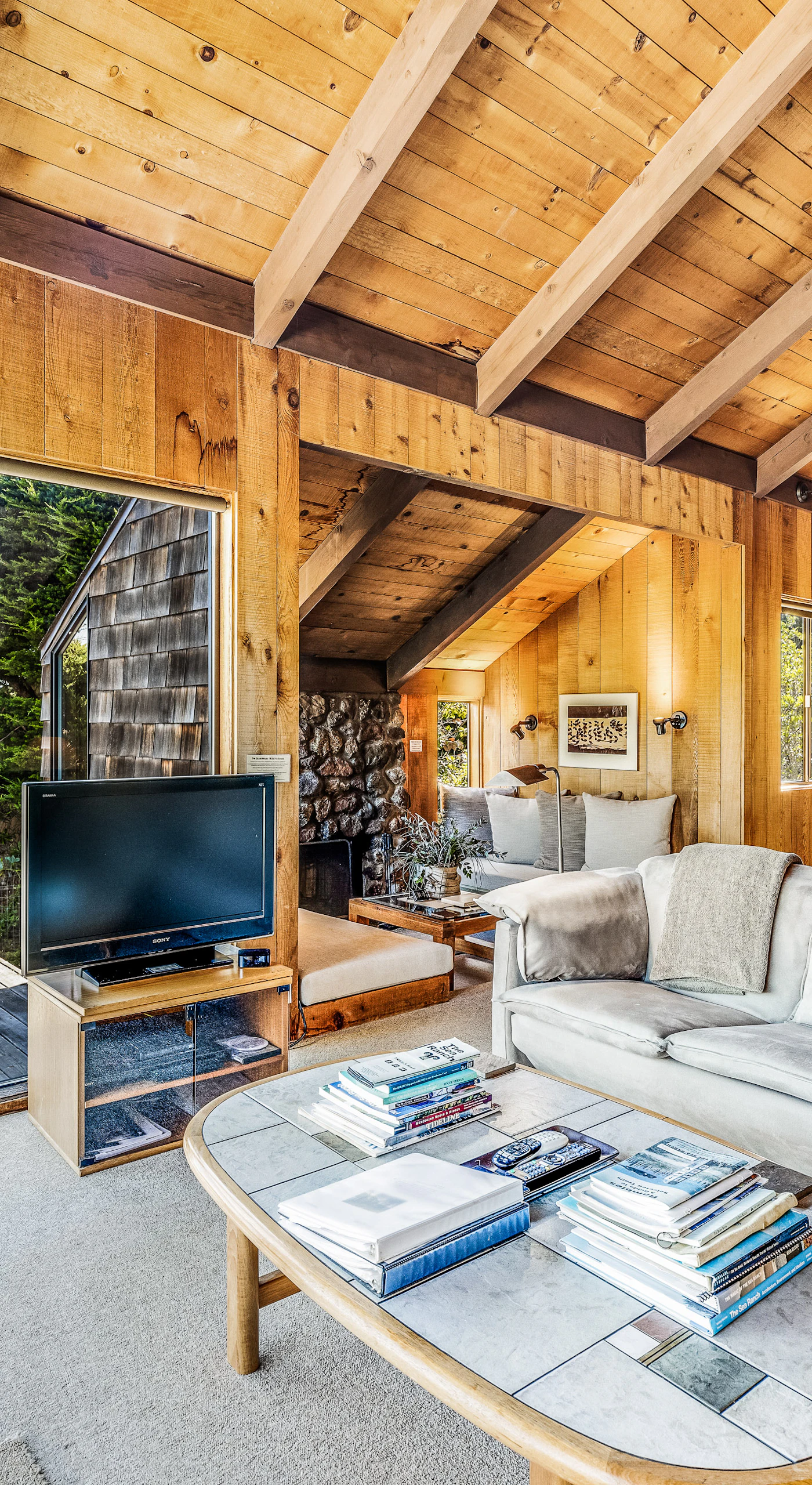 Bask in the warmth of the wood-burning fireplace while enjoying the natural light pouring in from the large windows.