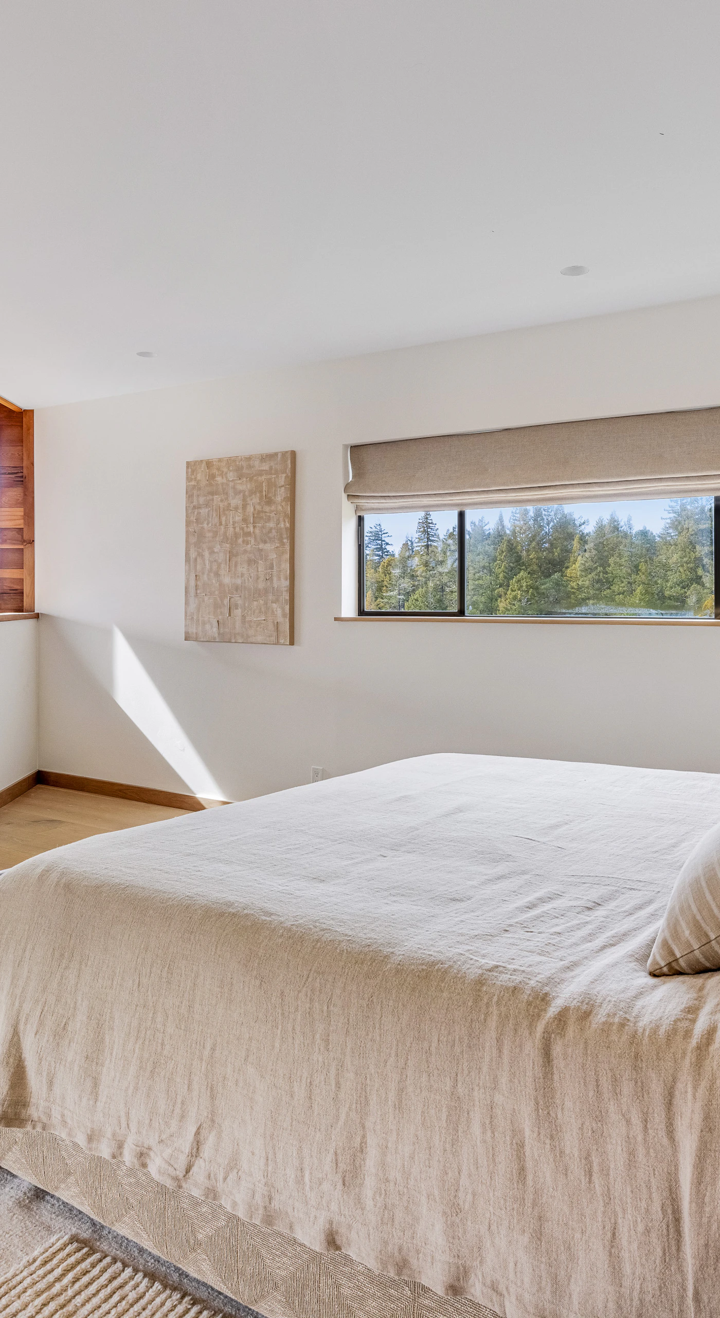 Morning light dances across this inviting master bedroom, offering a perfect escape for relaxation and rejuvenation in nature's embrace.