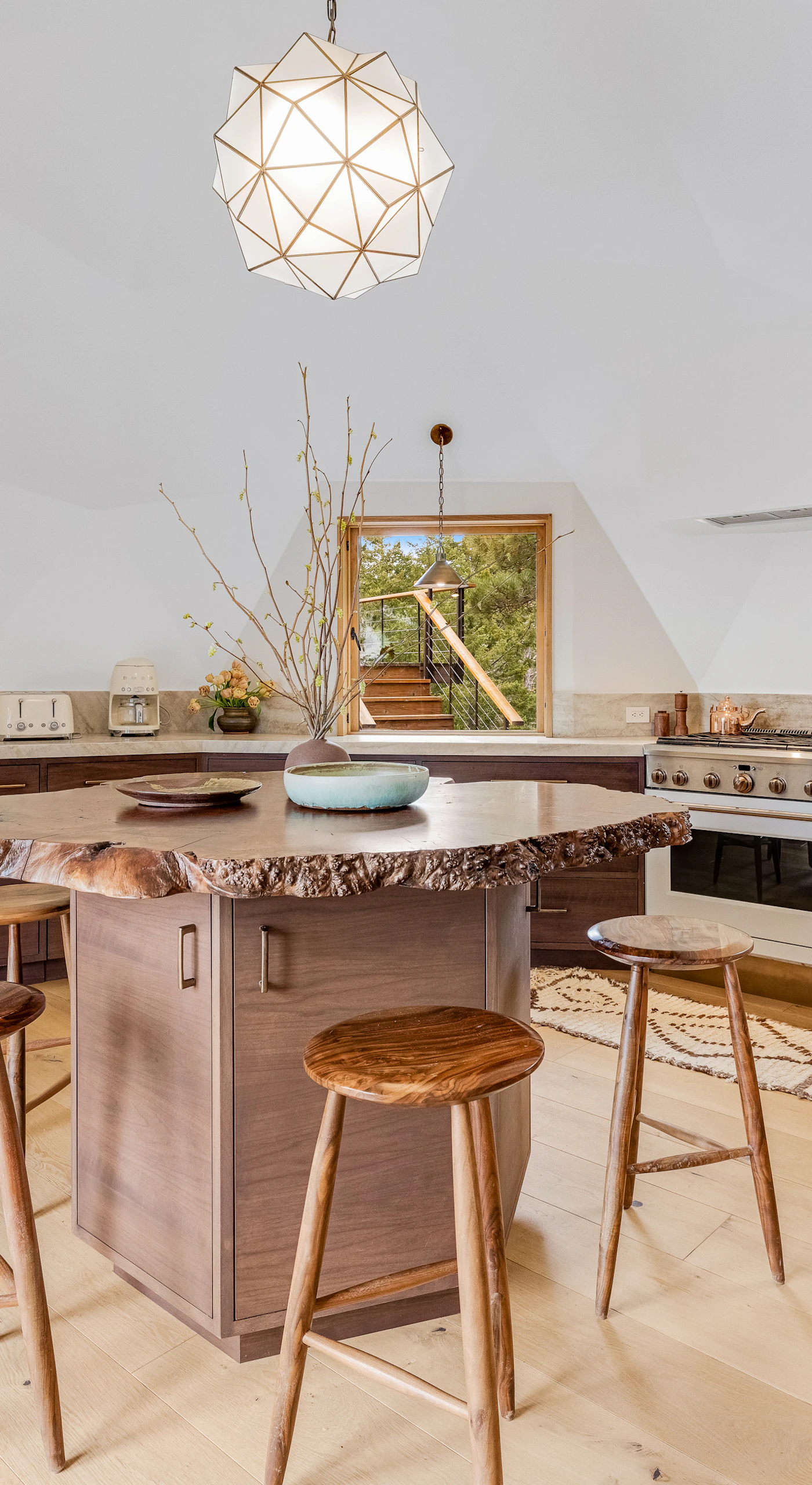 Gather around the unique island in this contemporary kitchen, an ideal spot for casual conversations while meals come to life.