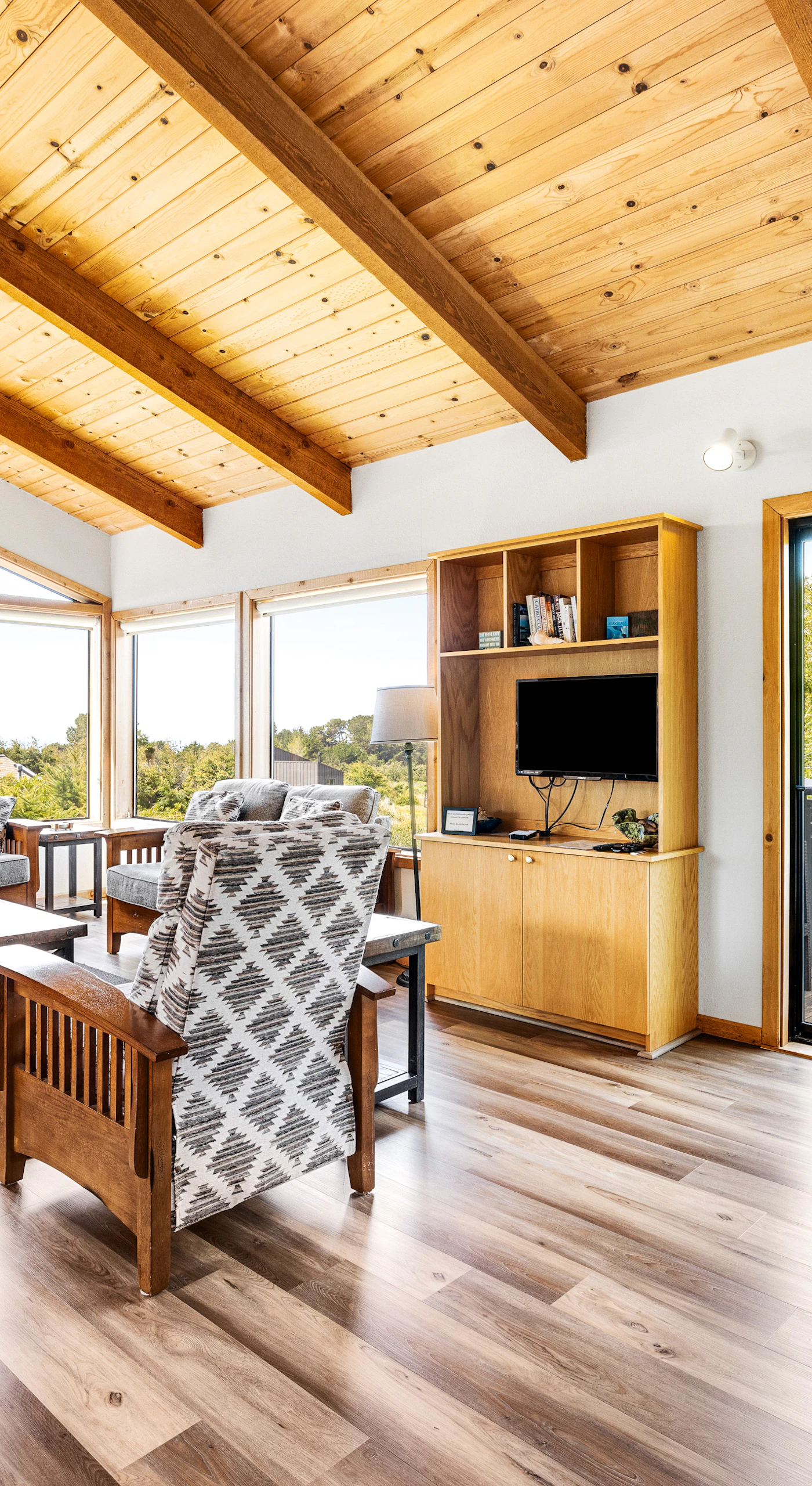 Morning light fills the living room, inviting you to unwind with a book or enjoy a cozy chat with loved ones in this inviting space.
