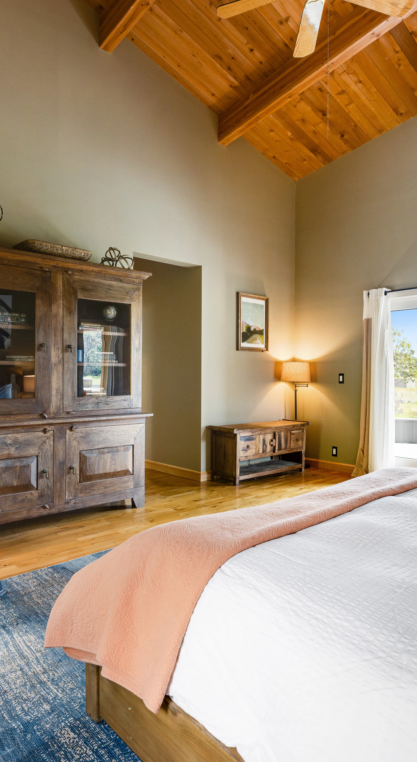 Feel at home in this stylish master bedroom, where high ceilings and rich textures create a warm and welcoming retreat.