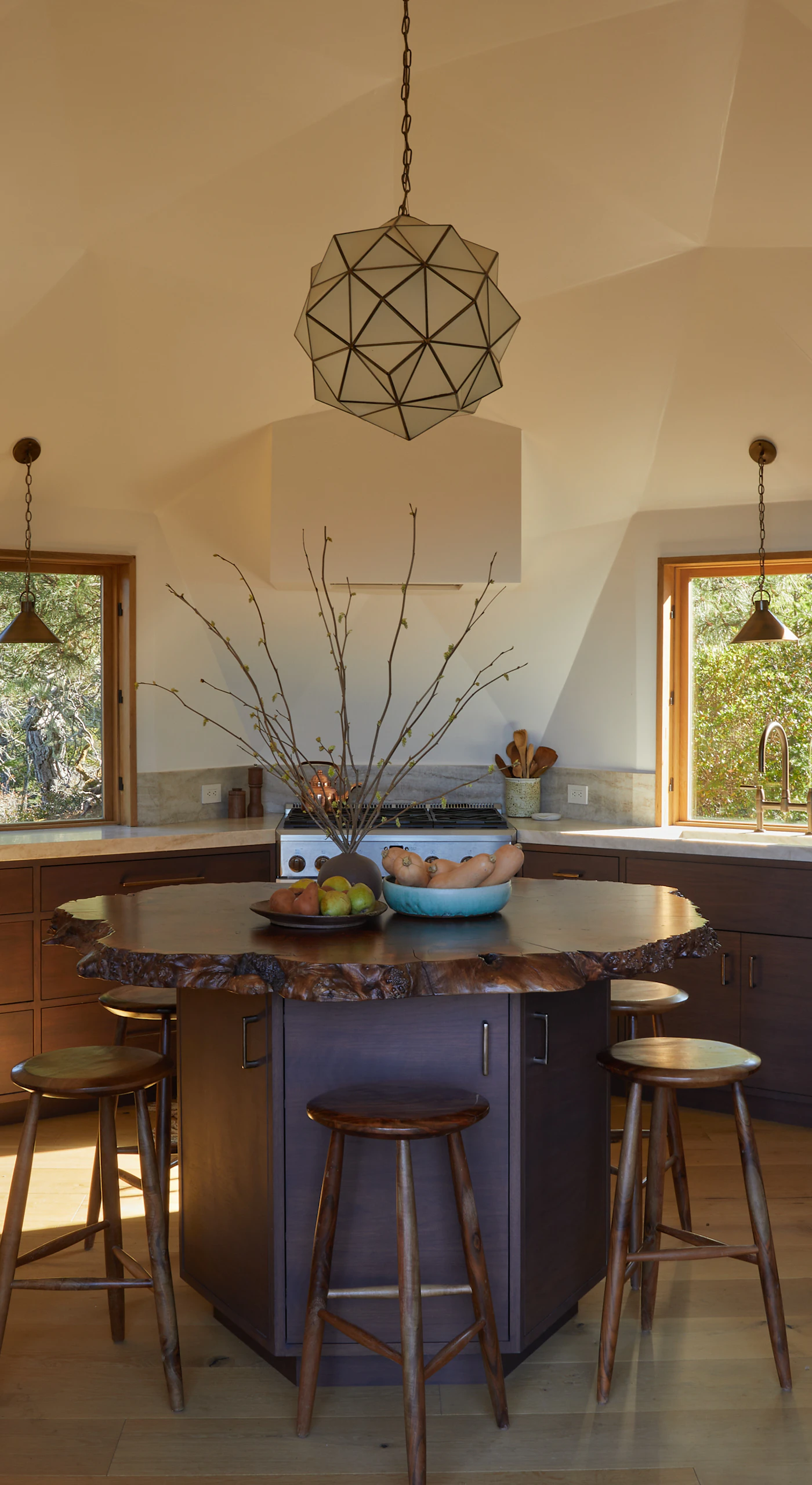 Craft culinary delights in this modern kitchen, where natural light pours in, making meal prep a joyful experience with stunning views to inspire you.