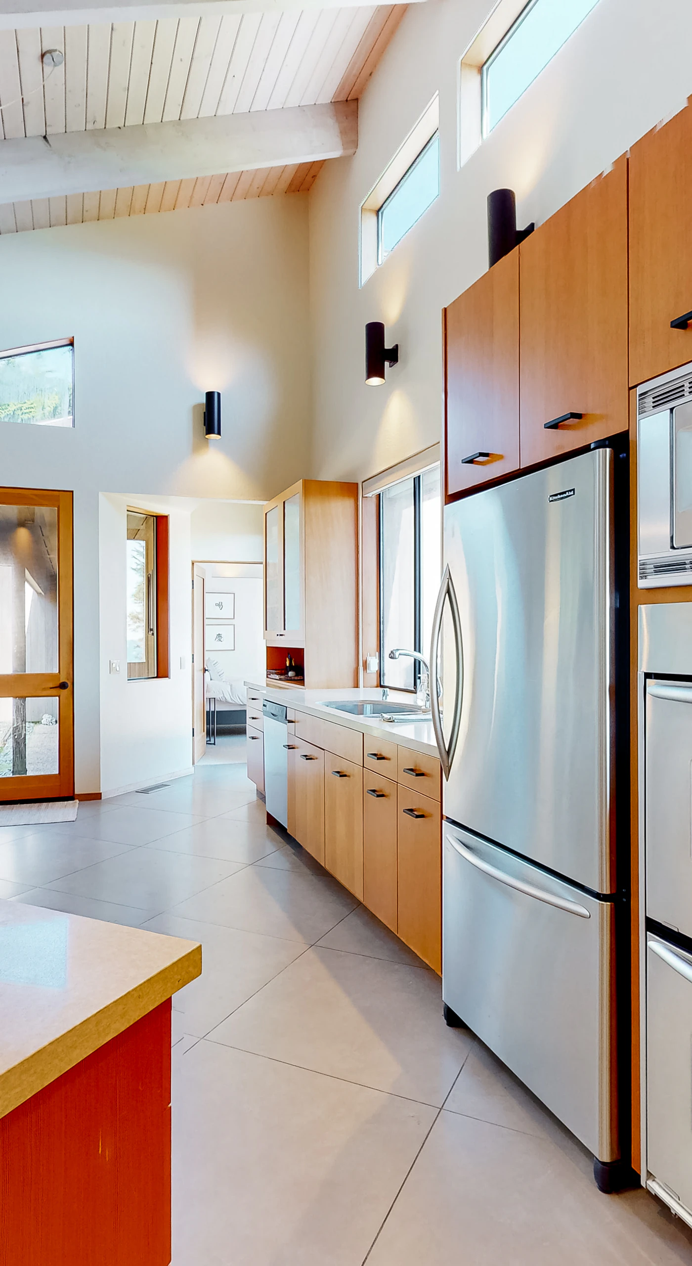 Unleash your culinary creativity in this modern kitchen, equipped with high-end appliances, where meal prep becomes a delightful experience with ocean views.