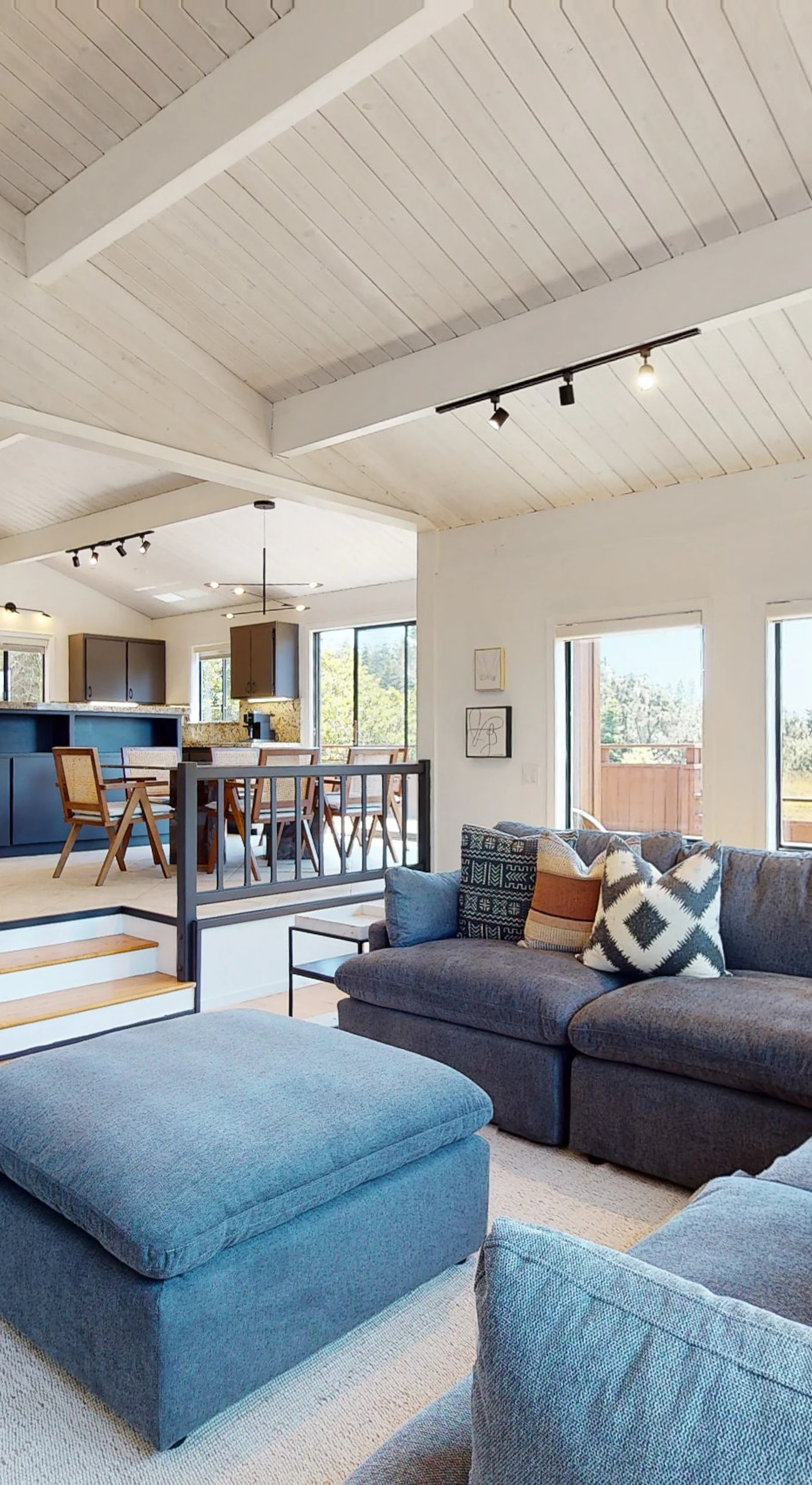 Gather around the spacious living room, where natural light streams through large windows, inviting laughter and conversation among friends and family.
