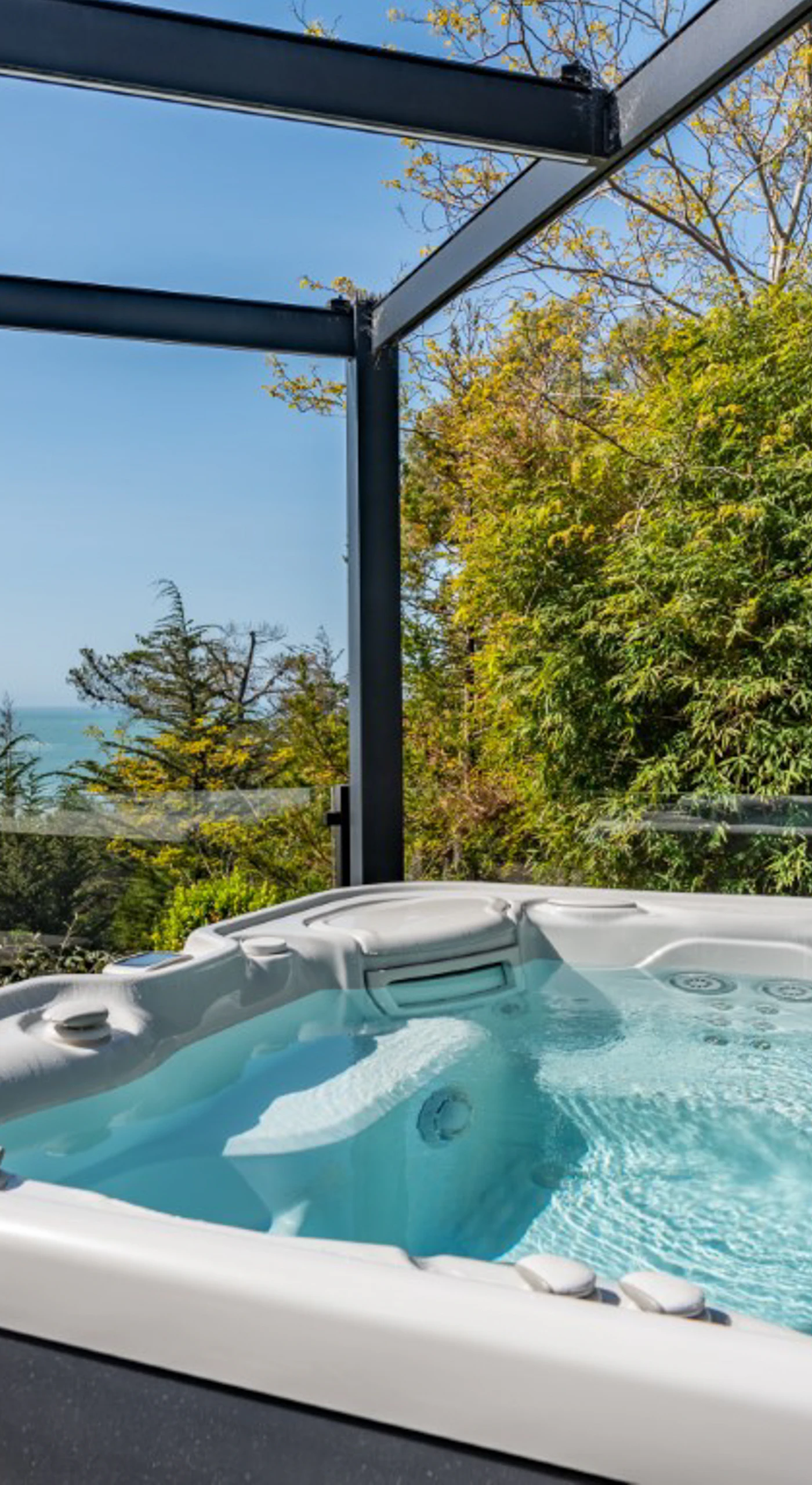Soak in your private hot tub while gazing at the endless ocean views, the perfect way to unwind after a day of adventure.