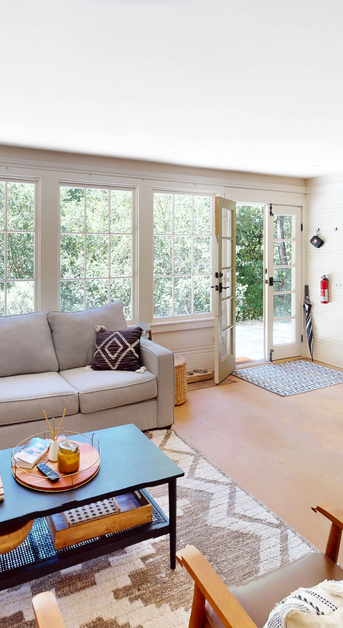 Natural light pours through your open-plan living and dining area where French doors lead straight to the patio — the redwood forest is never more than a glance away.