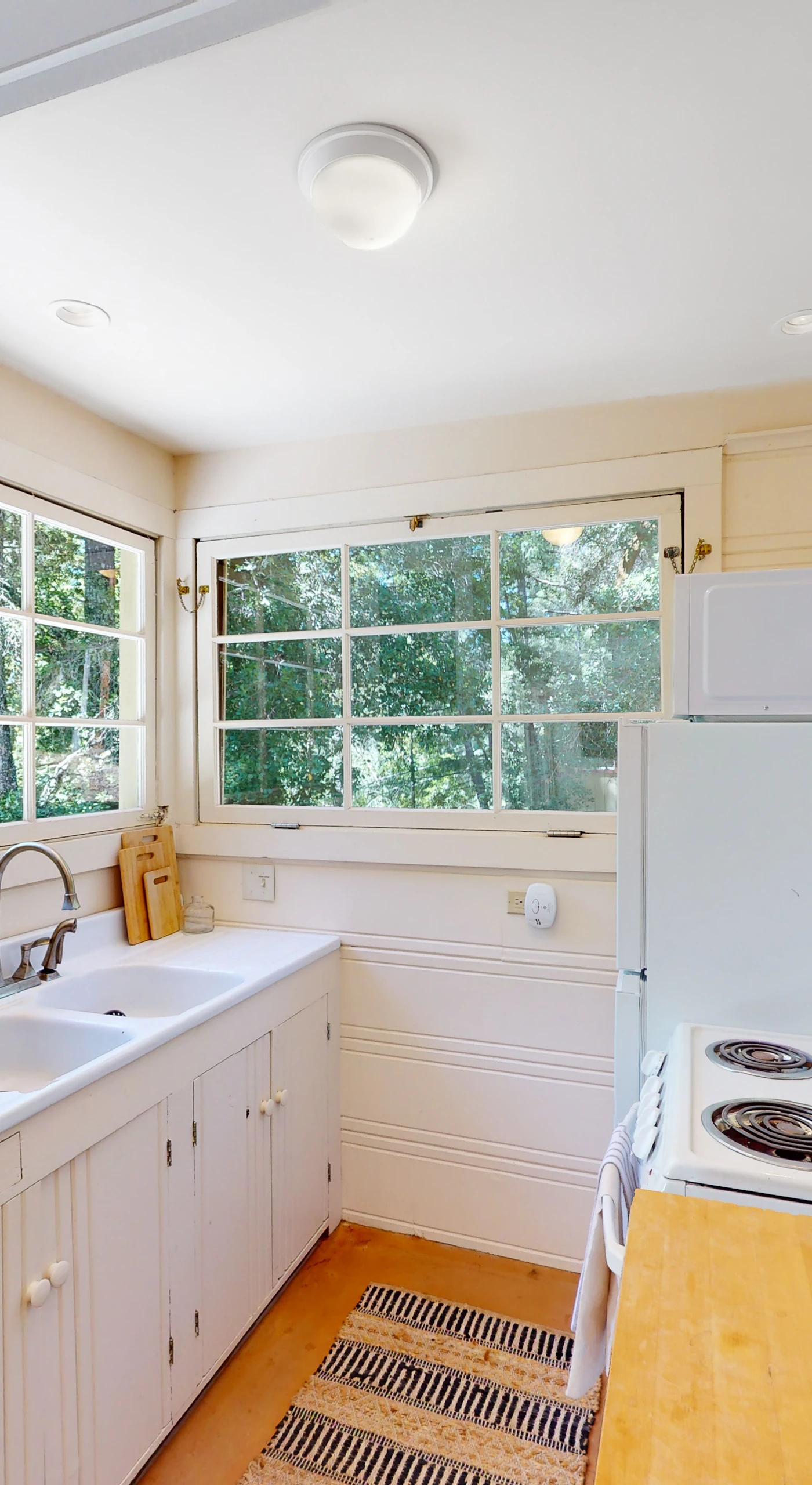 Whip up farm-to-table meals in your fully equipped galley kitchen — the window above the sink frames a living wall of green that makes prep work a pleasure.