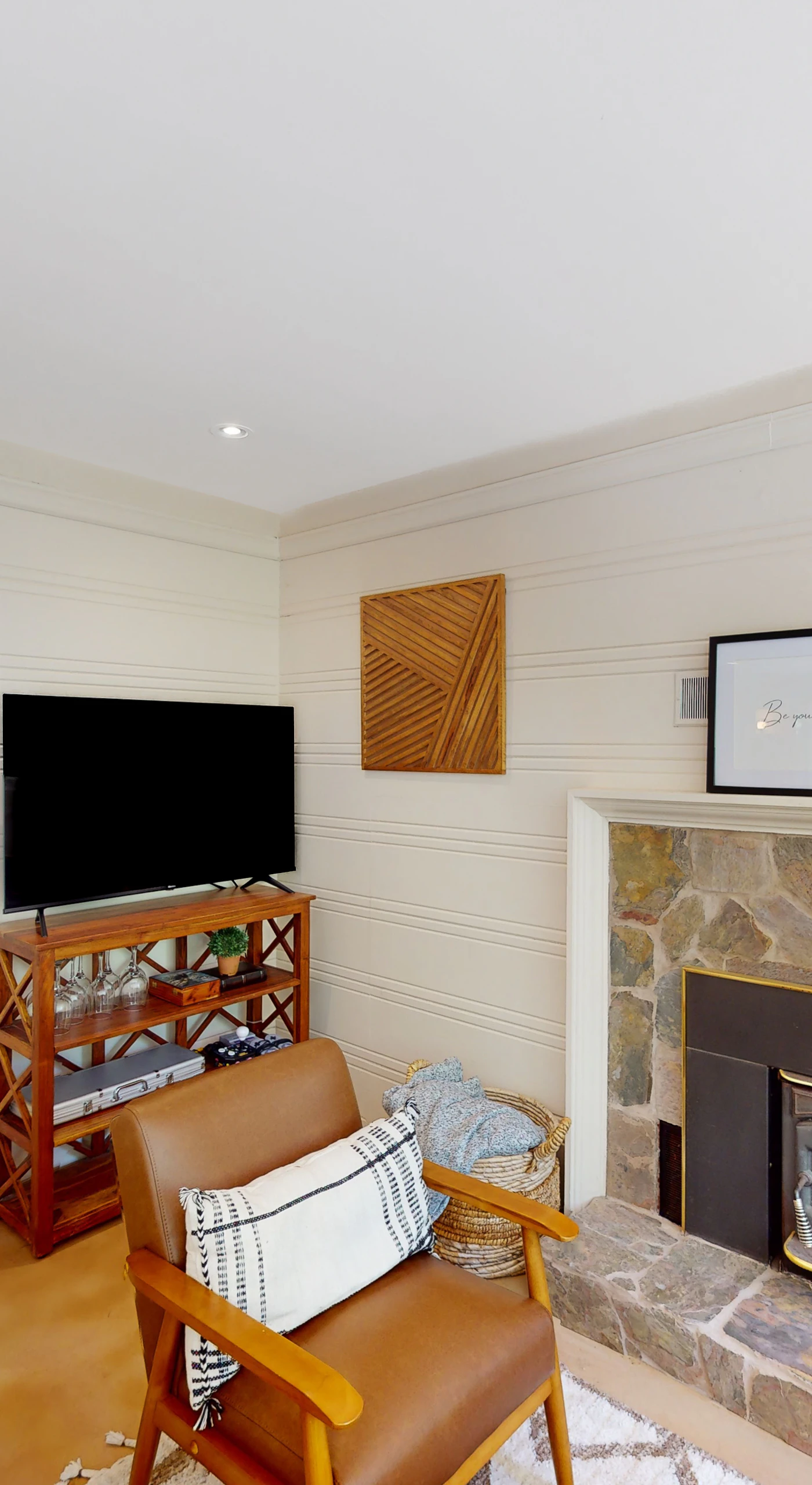 Cozy up by the stone-surround fireplace with your favorite show on the flatscreen — a vintage wine rack and curated art complete your evenings at Hidden Acres.