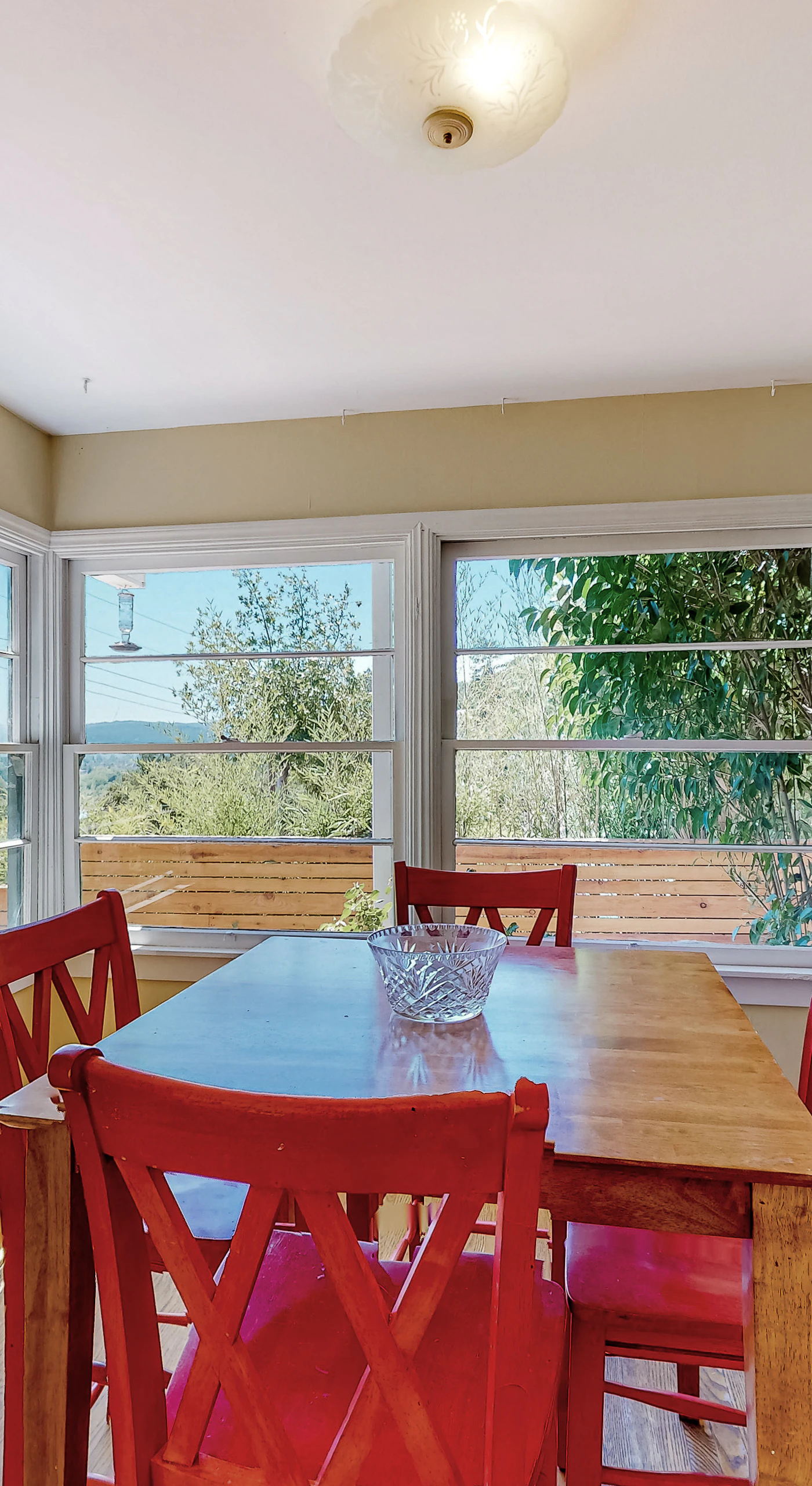 Linger over breakfast at your charming farmhouse dining table — sunlight pours through panoramic windows framing Healdsburg's rolling green hills.