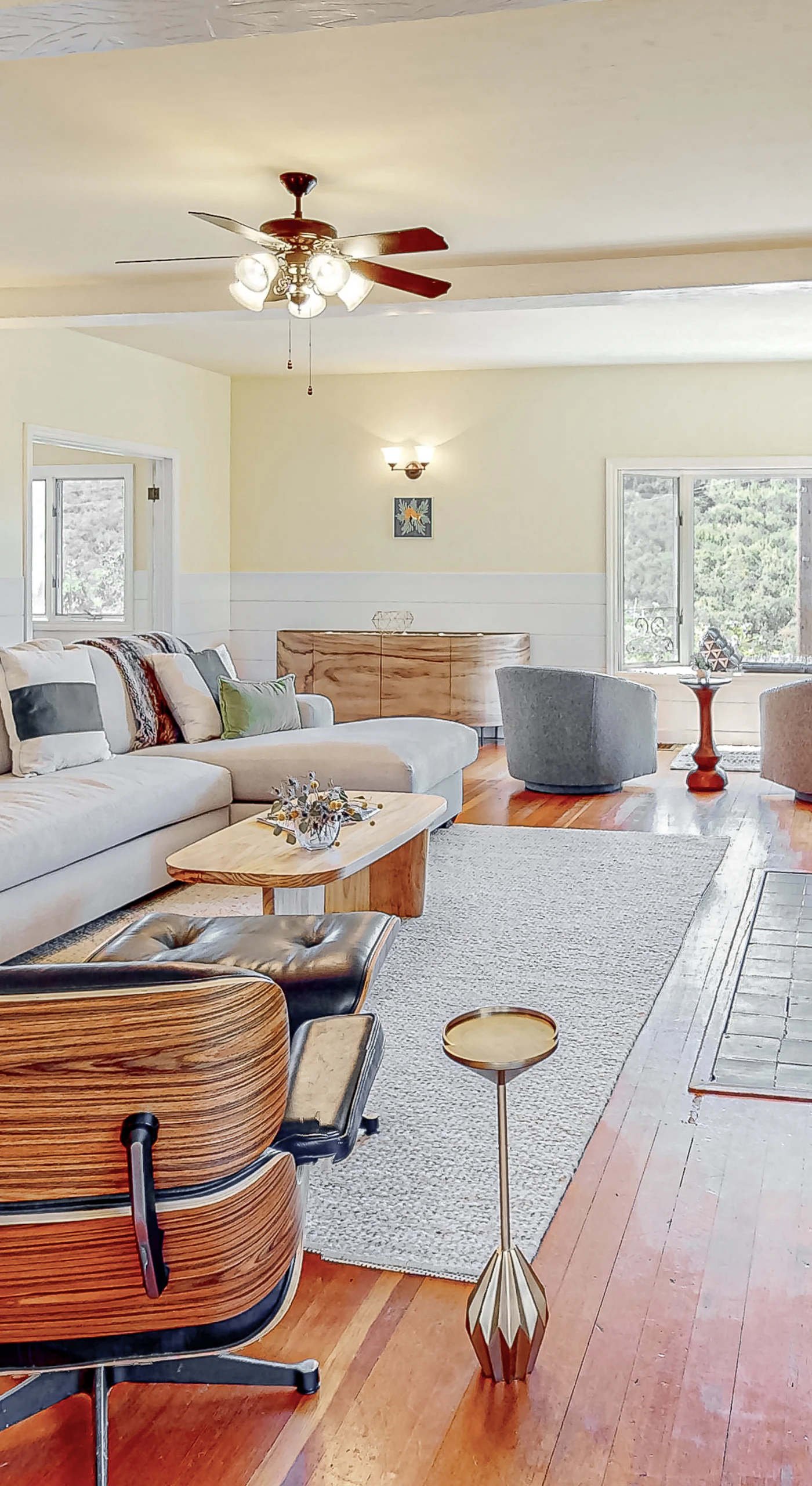 Warm mid-century style meets Healdsburg charm — settle into the iconic lounge chair beside a stone hearth while afternoon light spills across gleaming hardwood floors.