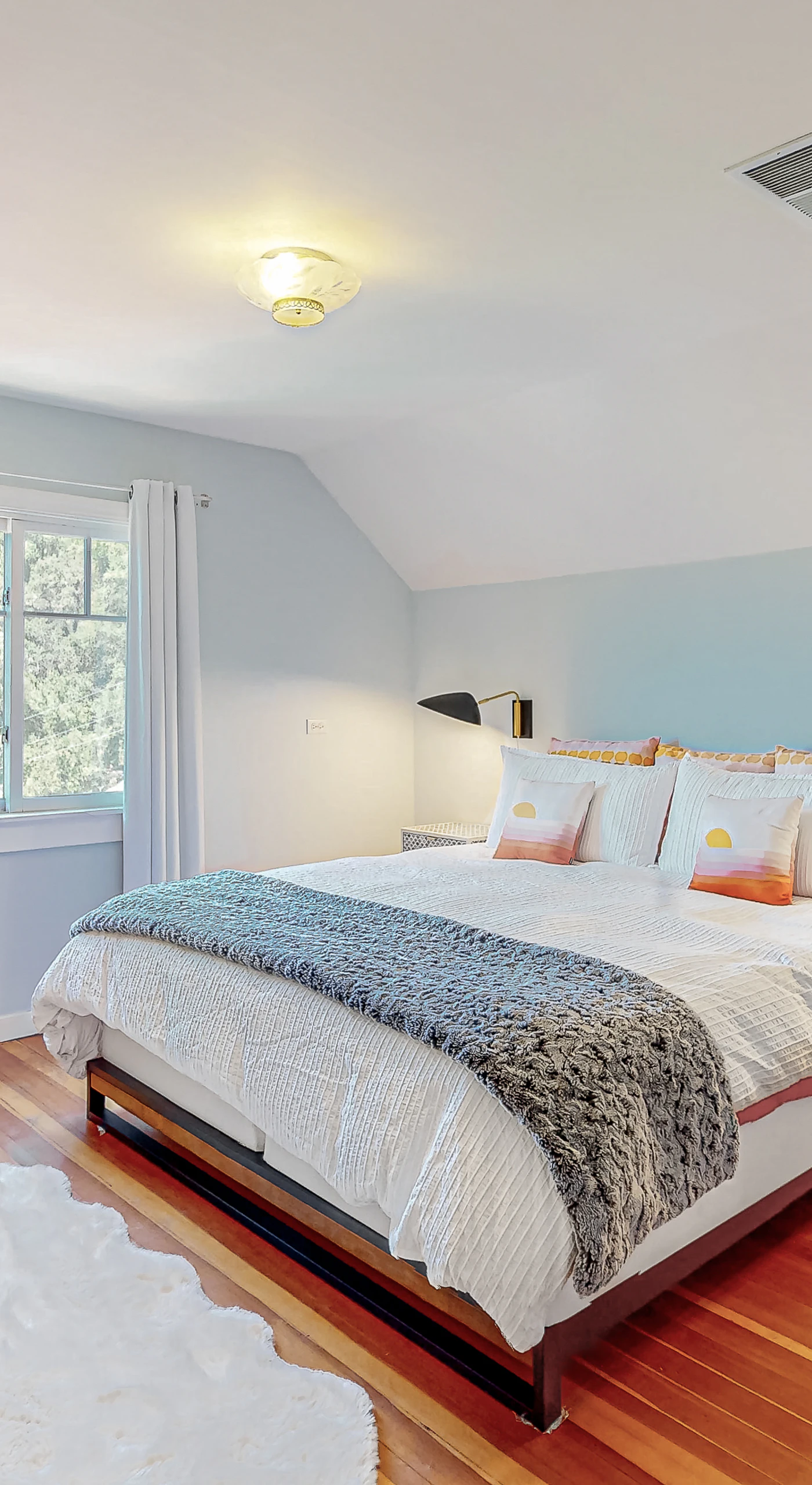 Wake to natural light beneath the vaulted ceiling of your airy Healdsburg retreat — hardwood floors and soft textiles create a restful wine country sanctuary.