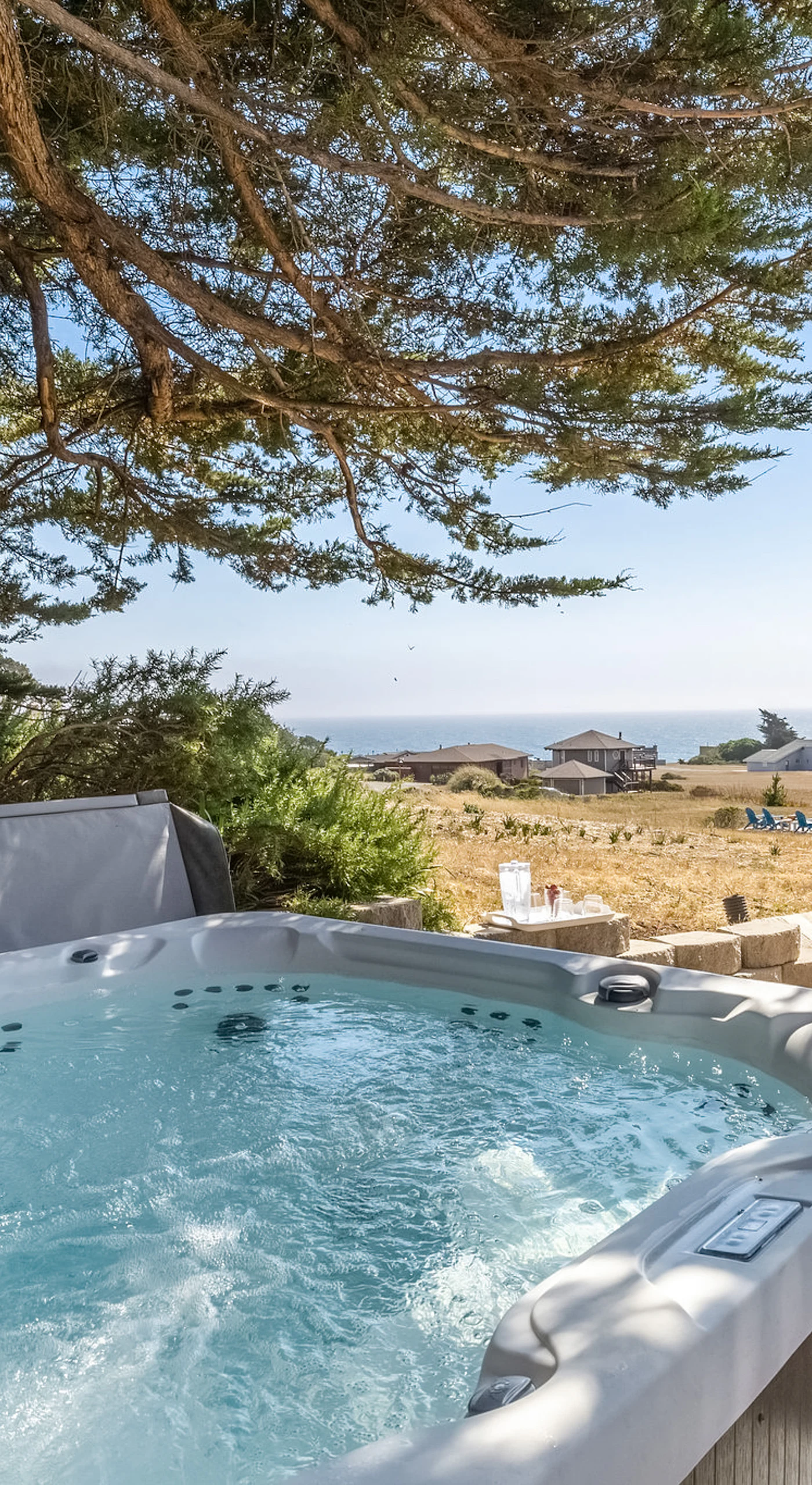 Melt away the day in your private hot tub tucked beneath coastal cypress trees, with Pacific breezes and ocean views as your backdrop