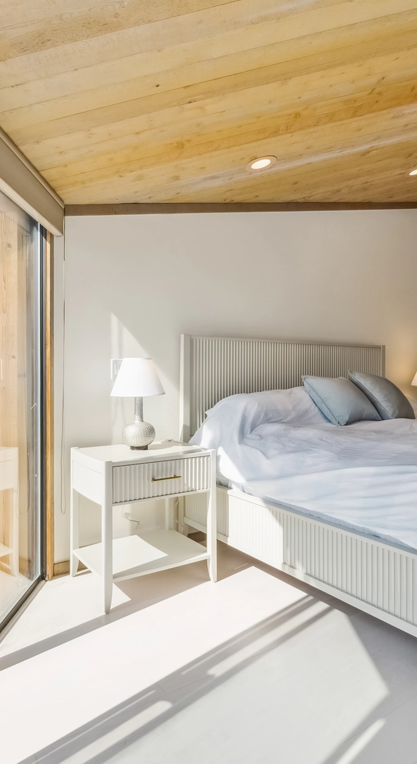 Morning light streams across your king bed through sliding glass doors—step outside onto the deck before breakfast and breathe in the salt air
