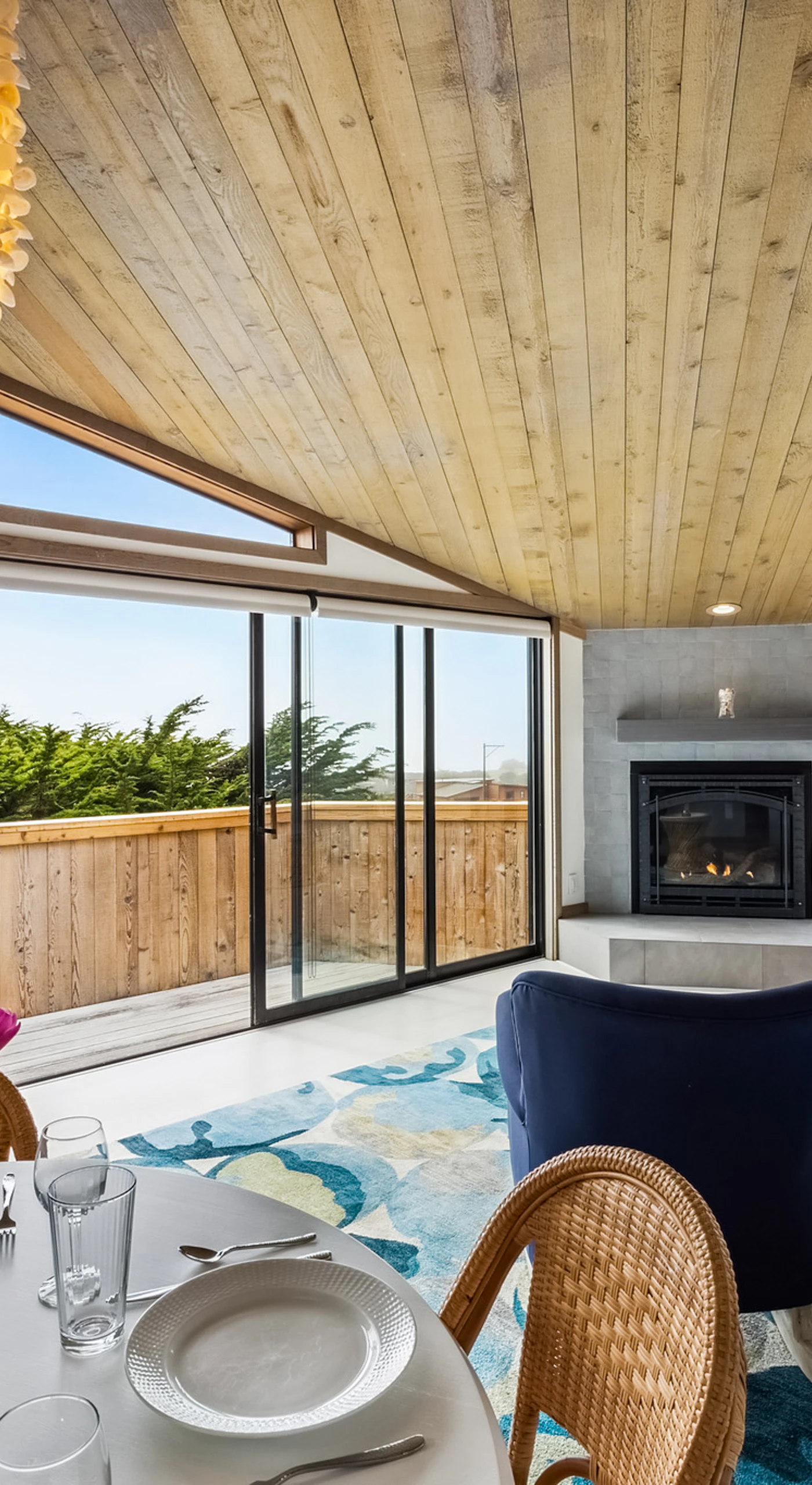 From candlelit dinners to lazy coastal mornings, your open great room connects kitchen, dining, and fireside lounging under one soaring roof