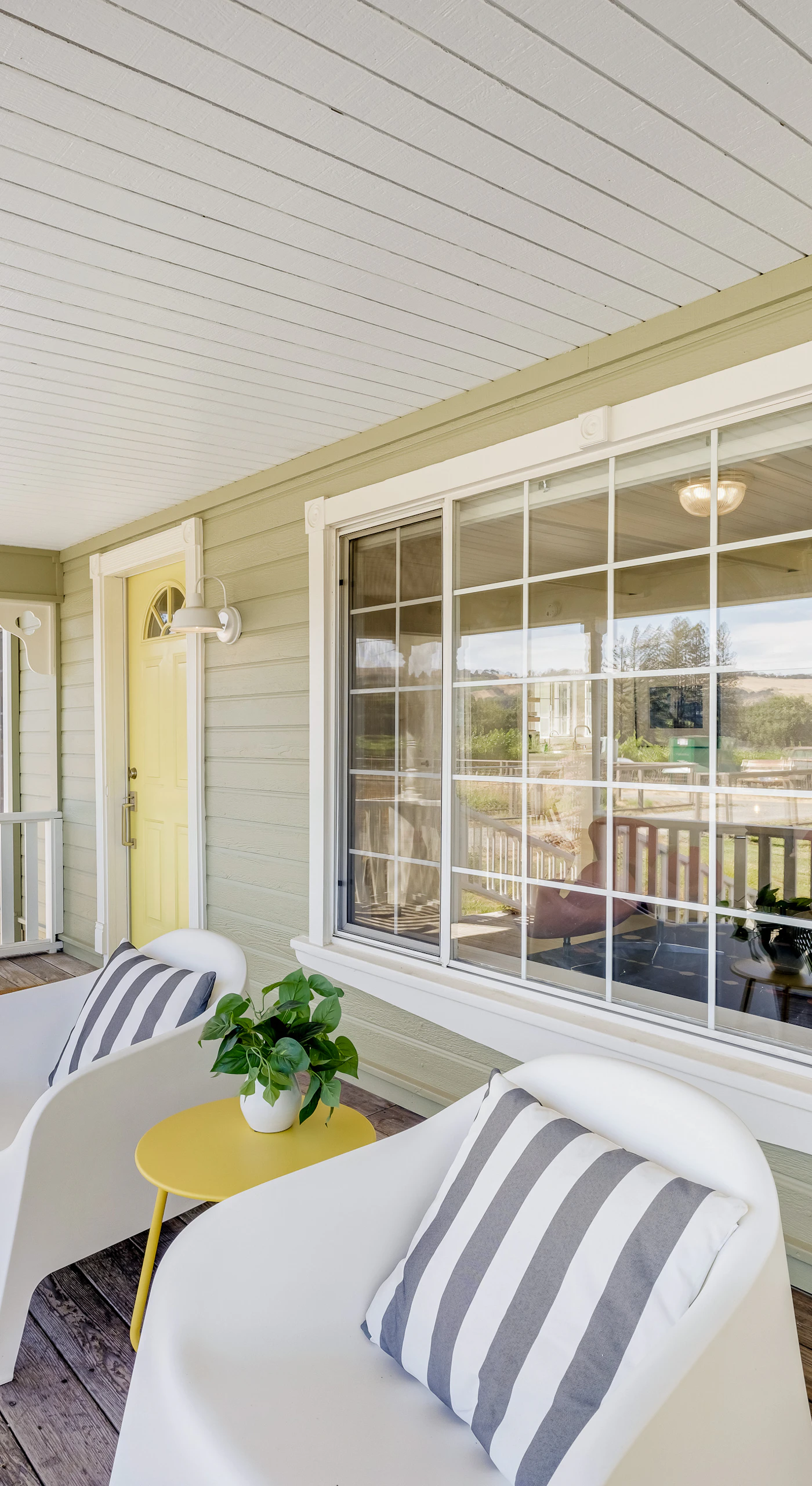 Morning coffee tastes better on your covered front porch — striped-pillow loungers face the Healdsburg countryside, inviting you to slow down and sip.