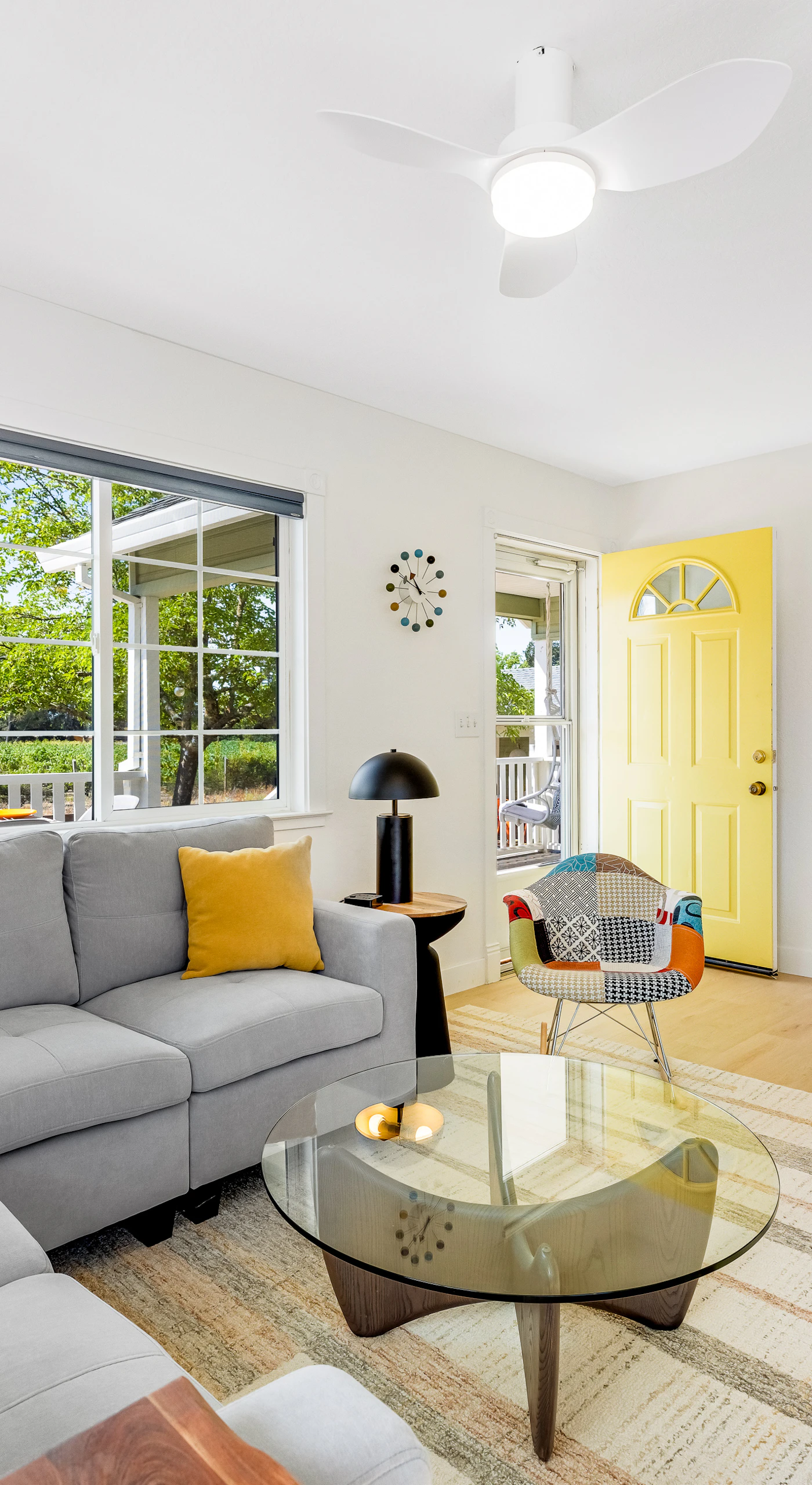 Unwind on the gray sectional with your favorite Dry Creek Valley red — warm light, curated art, and that signature yellow farmhouse door welcoming you home.