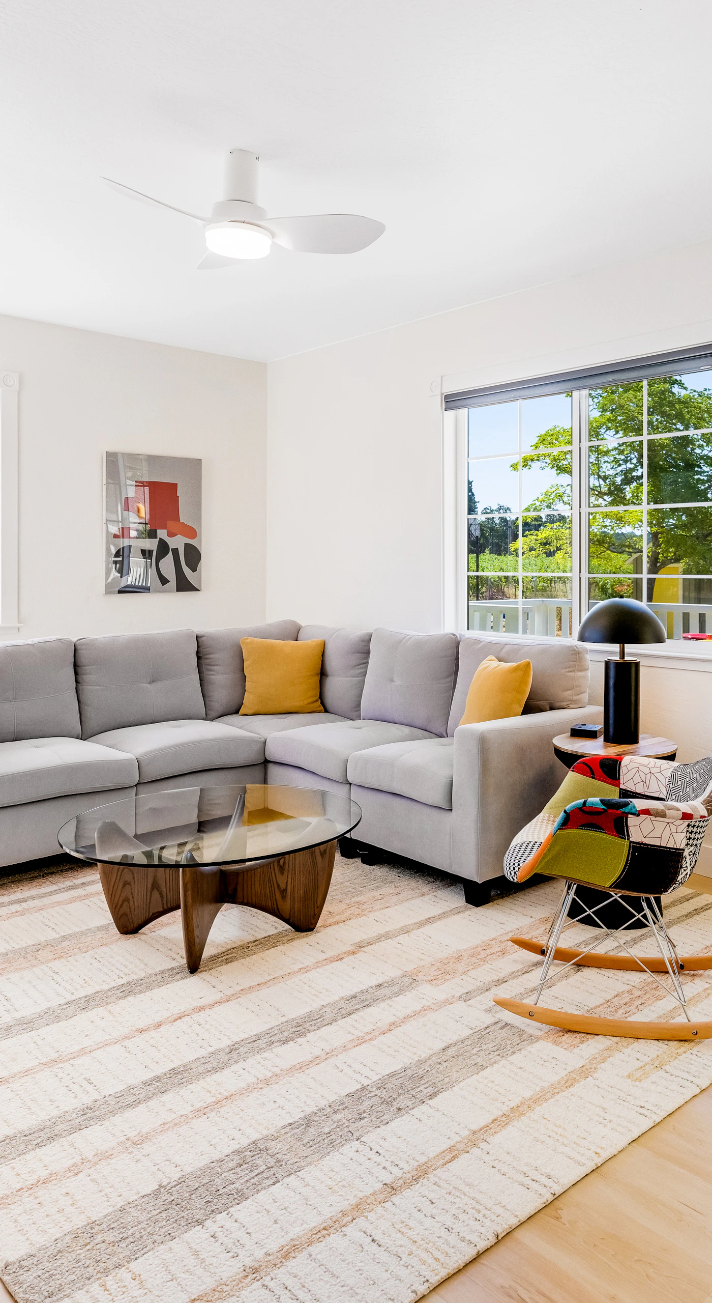 Sink into your sun-filled living room after a day of Healdsburg tasting rooms — plush sectional, modern accents, and natural light pouring through every window.
