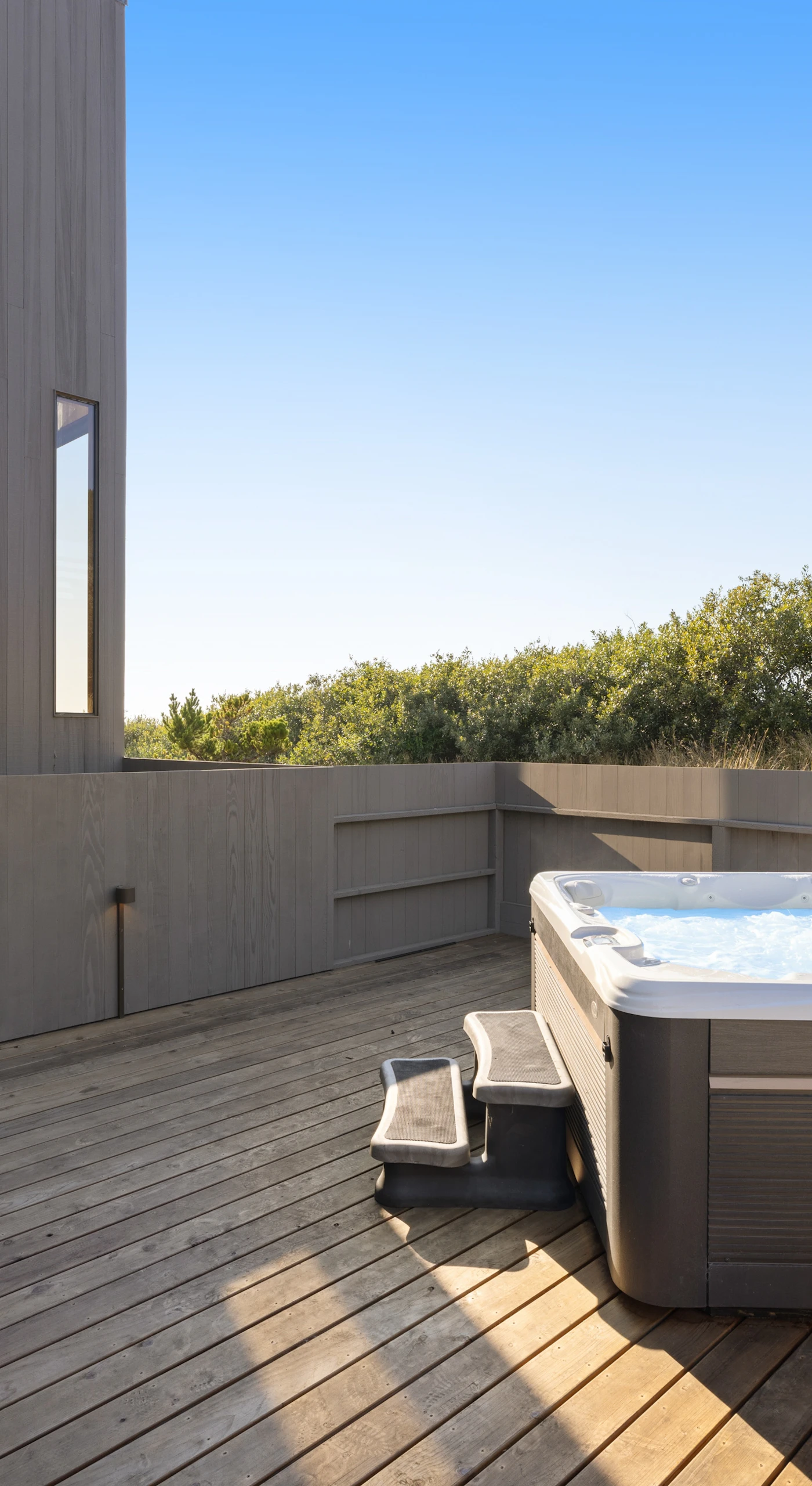 Step outside to your private hot tub, where you can soak under the stars and let the ocean breeze wash your cares away.