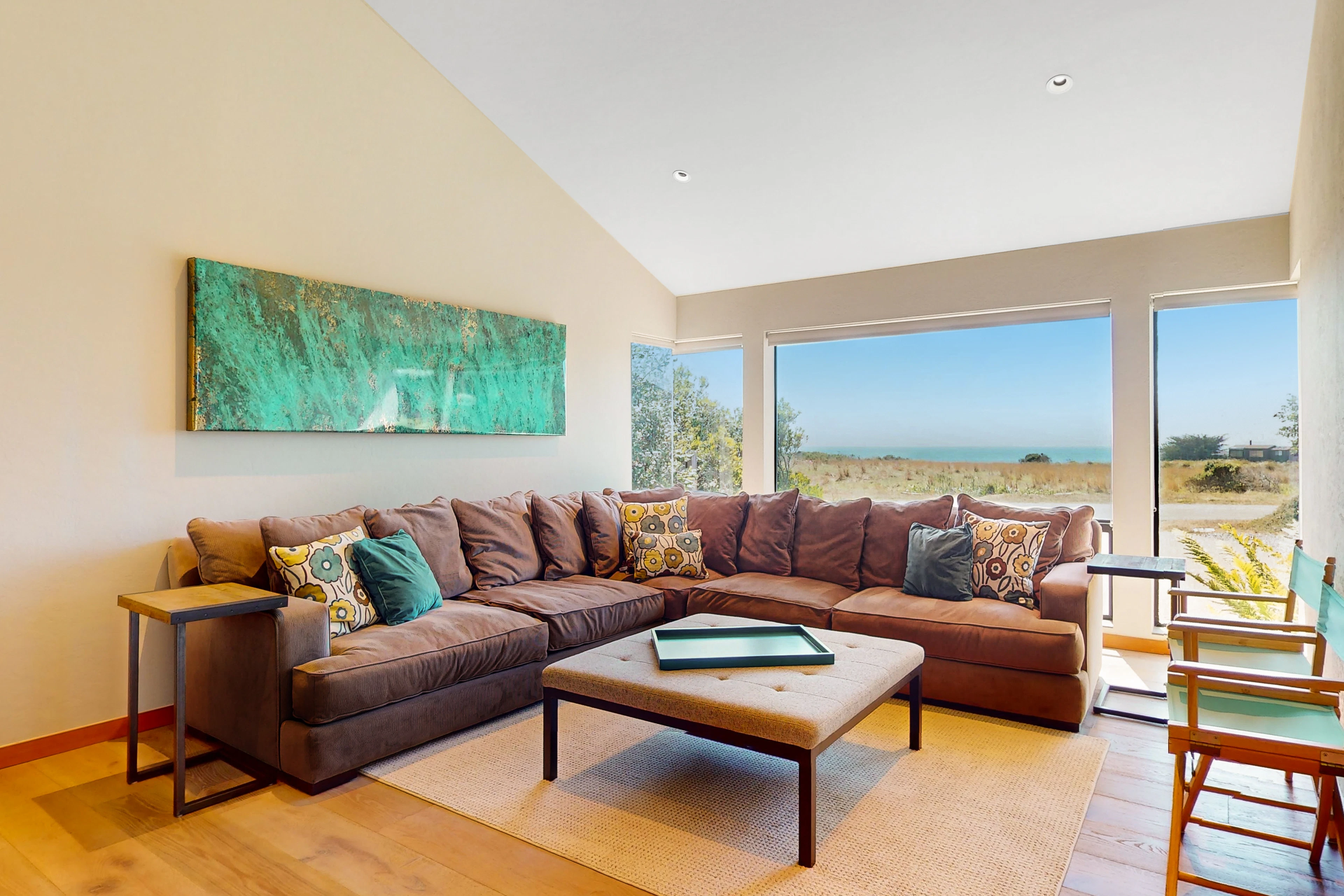 Gather your loved ones in this cozy living room, where natural light floods in and the ocean view sets the perfect backdrop.