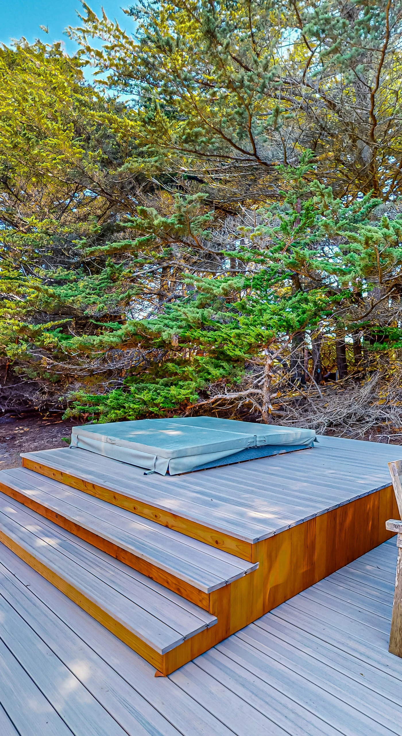 Step into your private hot tub and unwind surrounded by nature—ideal for stargazing after a day of coastal adventures.