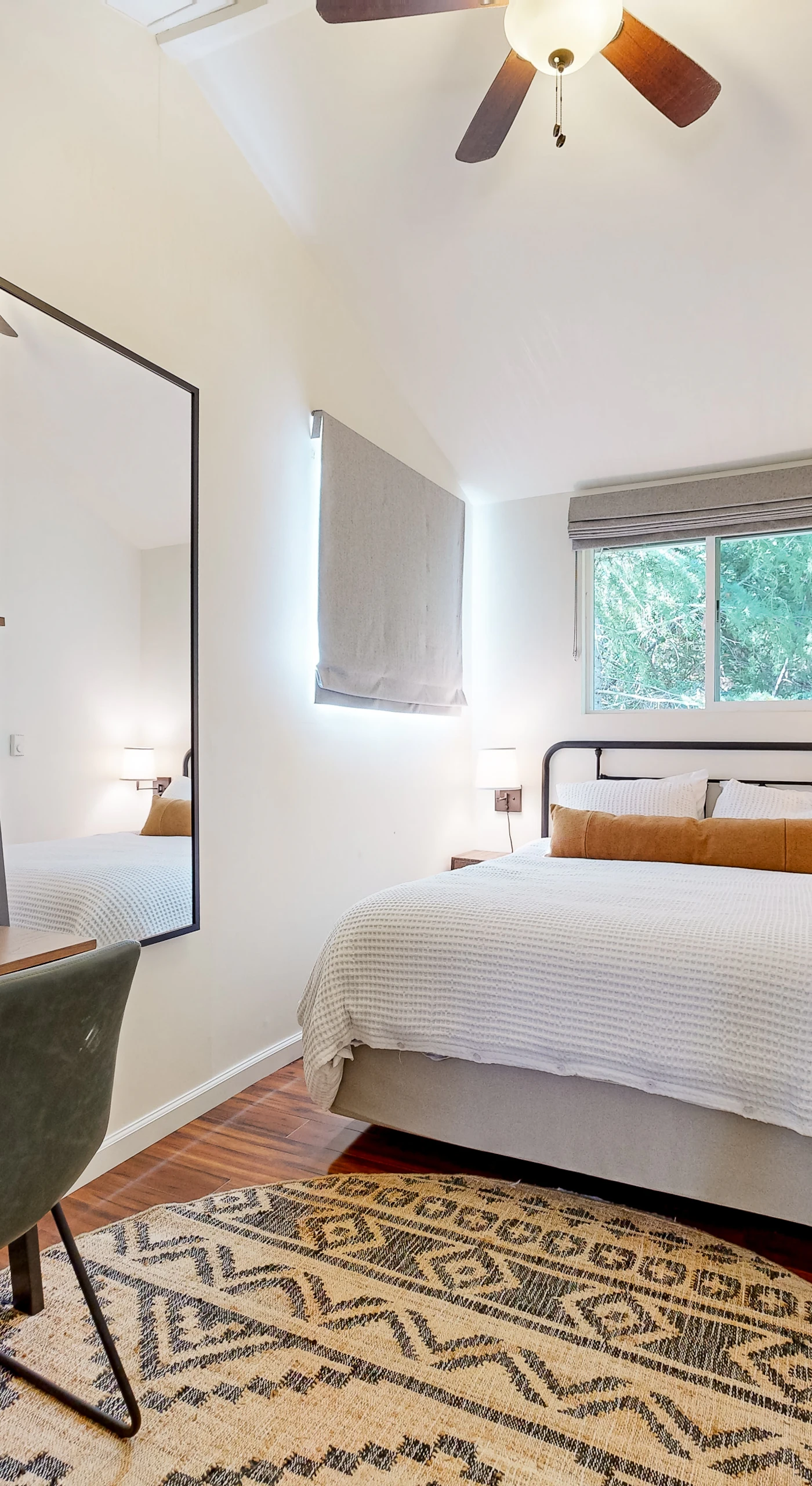 Recharge in your stylish guest bedroom featuring a queen bed, built-in desk workspace, and treetop views — ideal for catching up between Russian River adventures.