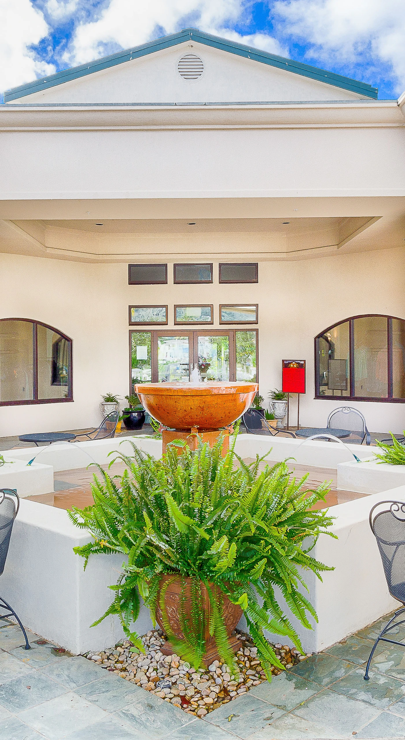 Gather around the elegant courtyard fountain at Silverado Resort — wrought iron café seating and open-air columns set the scene for your Napa escape.