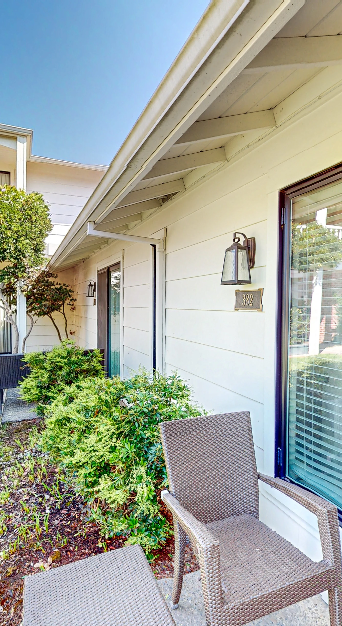 Step onto your private ground-level patio with wicker seating and take in the manicured resort lawn — your bedroom is just a sliding door away.